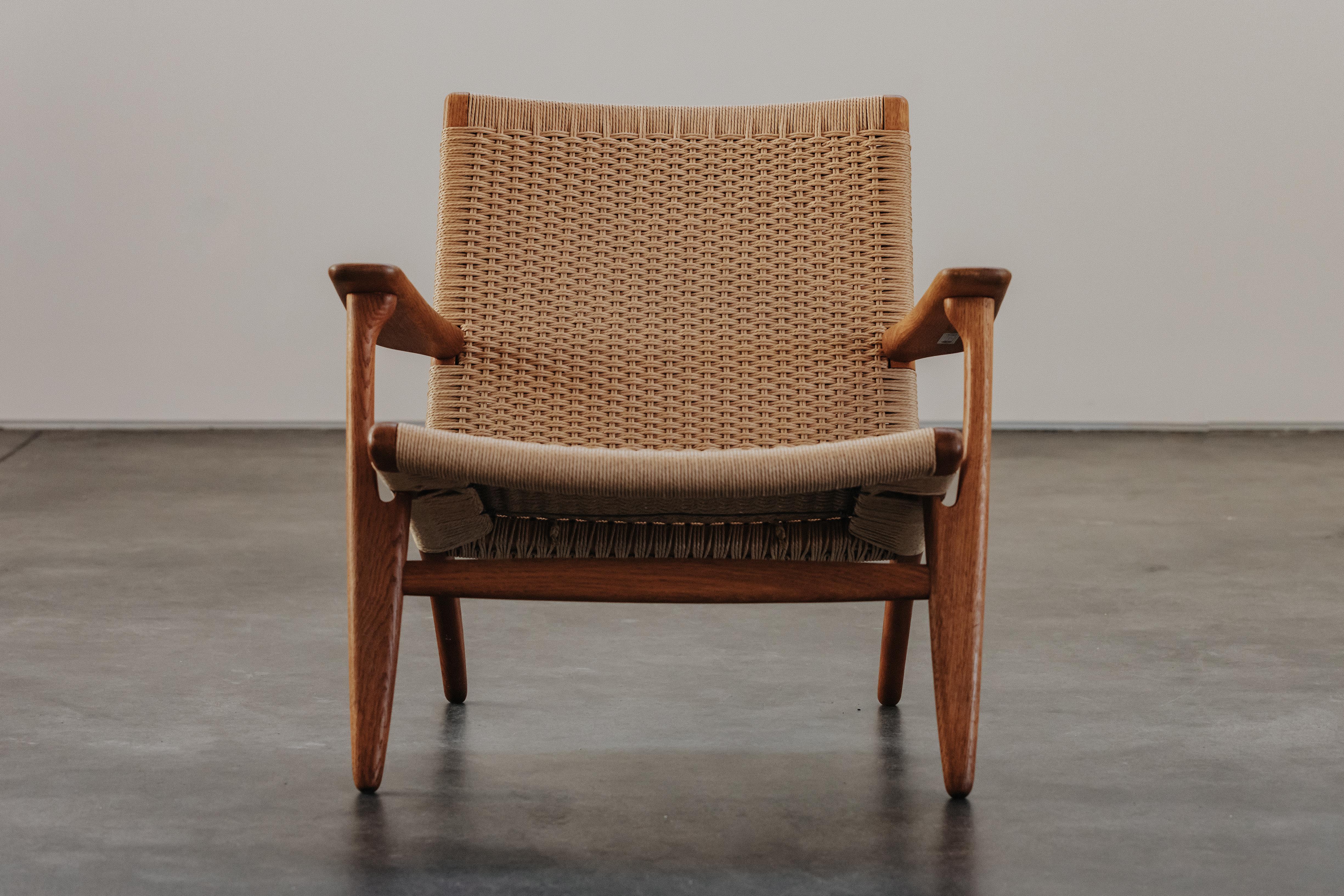 Vintage Hans Wegner Lounge Chair, Model CH25, From Denmark 1970.  Solid oak construction. New papercord.