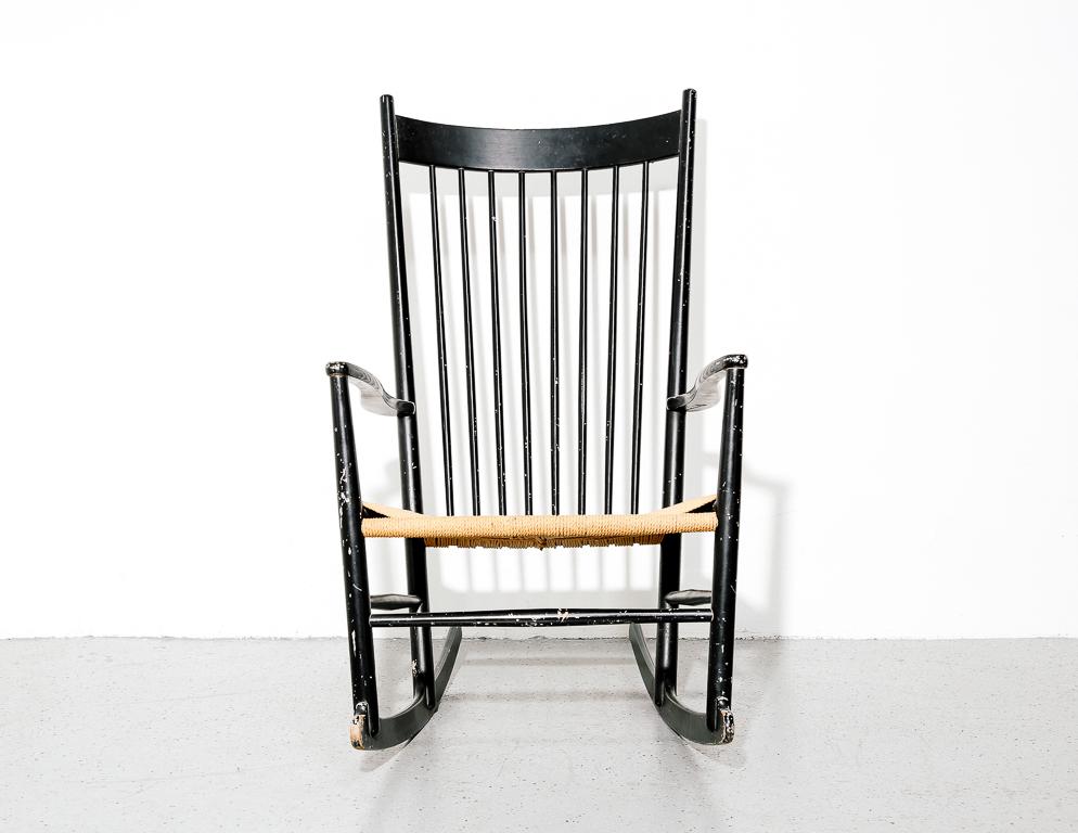 Shaker-influenced 'J16' rocking chair designed by Hans Wegner. Black lacquer frame with woven Danish paper cord seat.