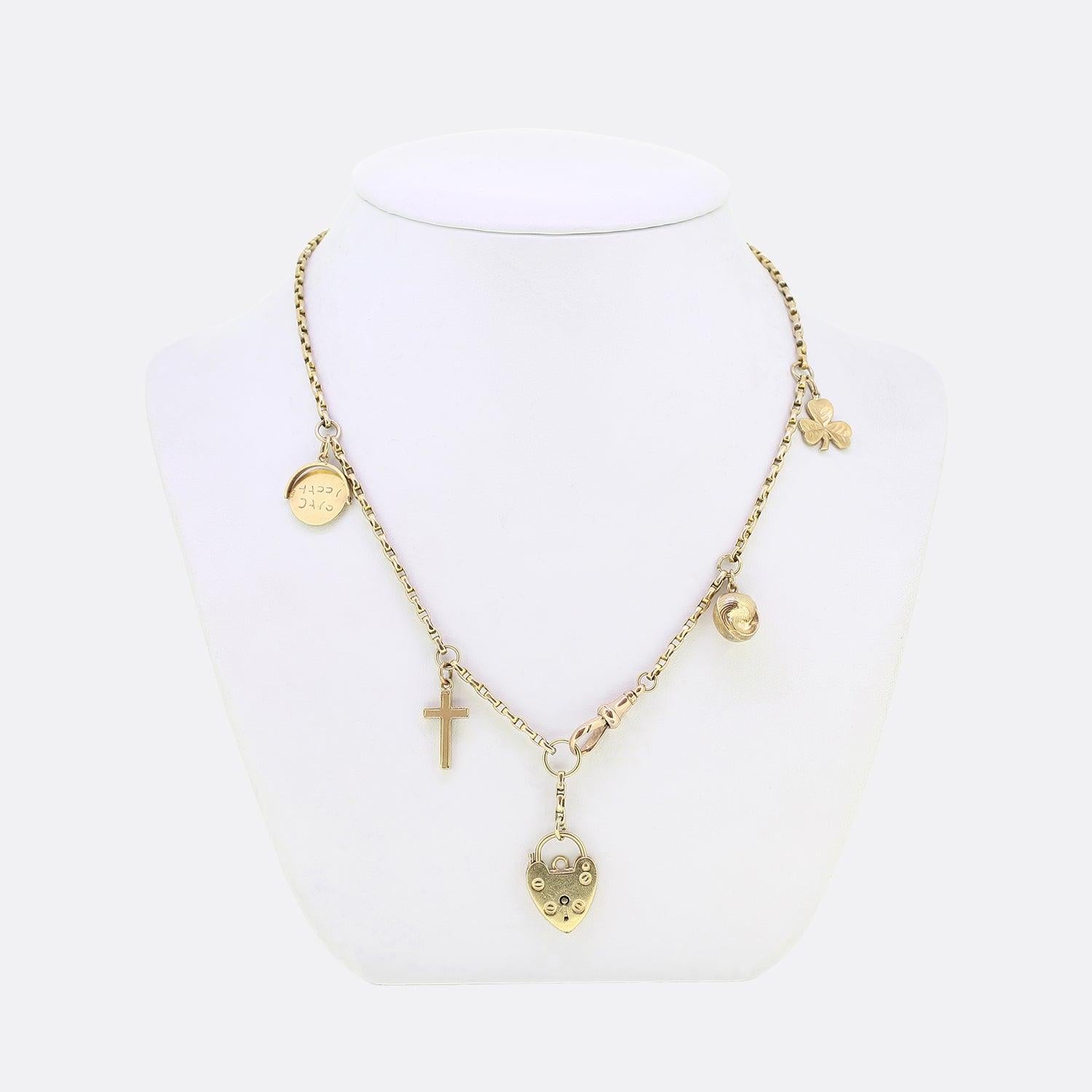 This is a vintage 9ct yellow gold belcher necklace. The necklace has charms attached through out the chain including a clover, a shell, a cross and a 'Happy Days' spinner. The necklace is attached securely by a swivel clasp.  

Condition: Used (Very