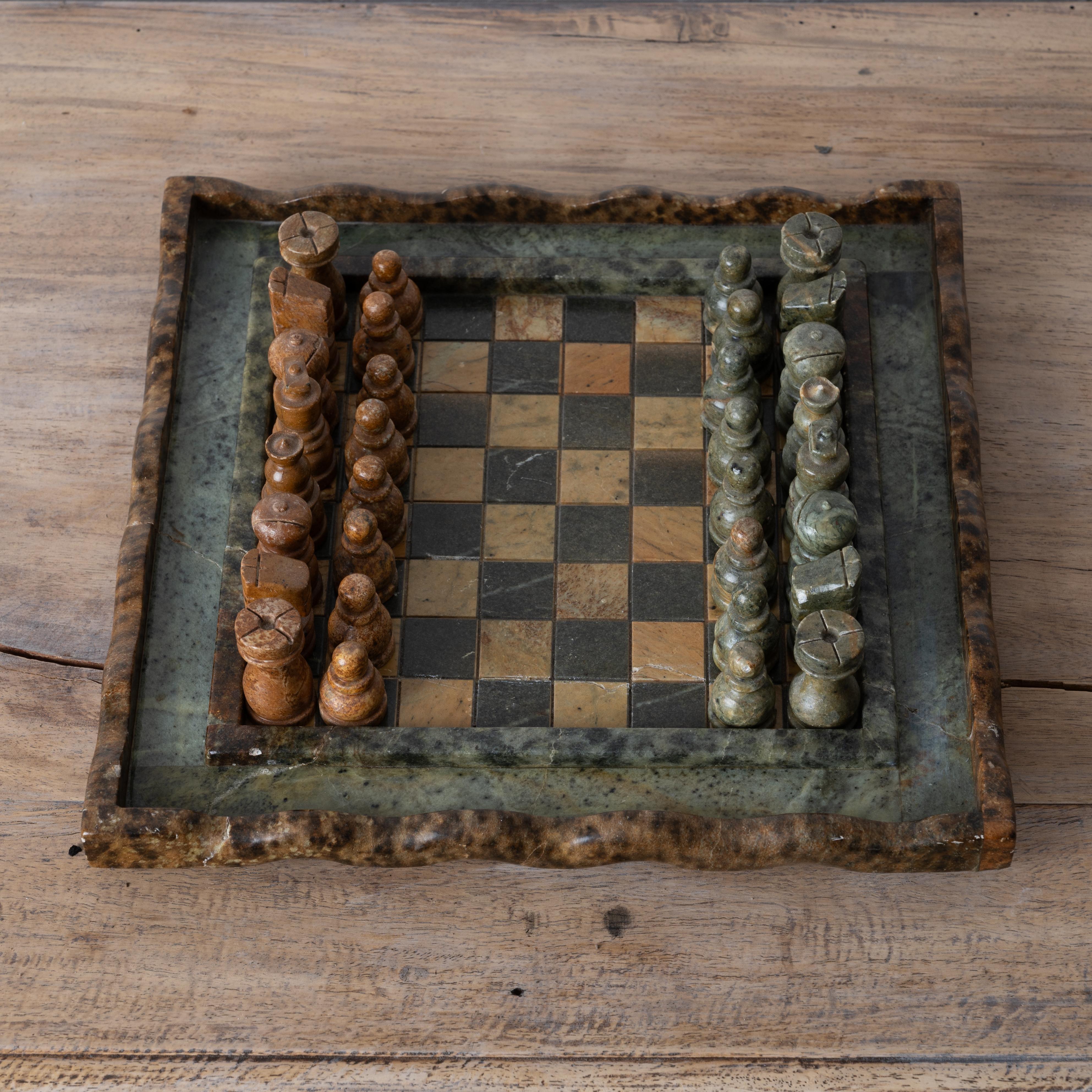 A vintage hardstone and marble chess set, mid-20th century.

12 inches wide by 12 inches deep by 3 inches tall 



