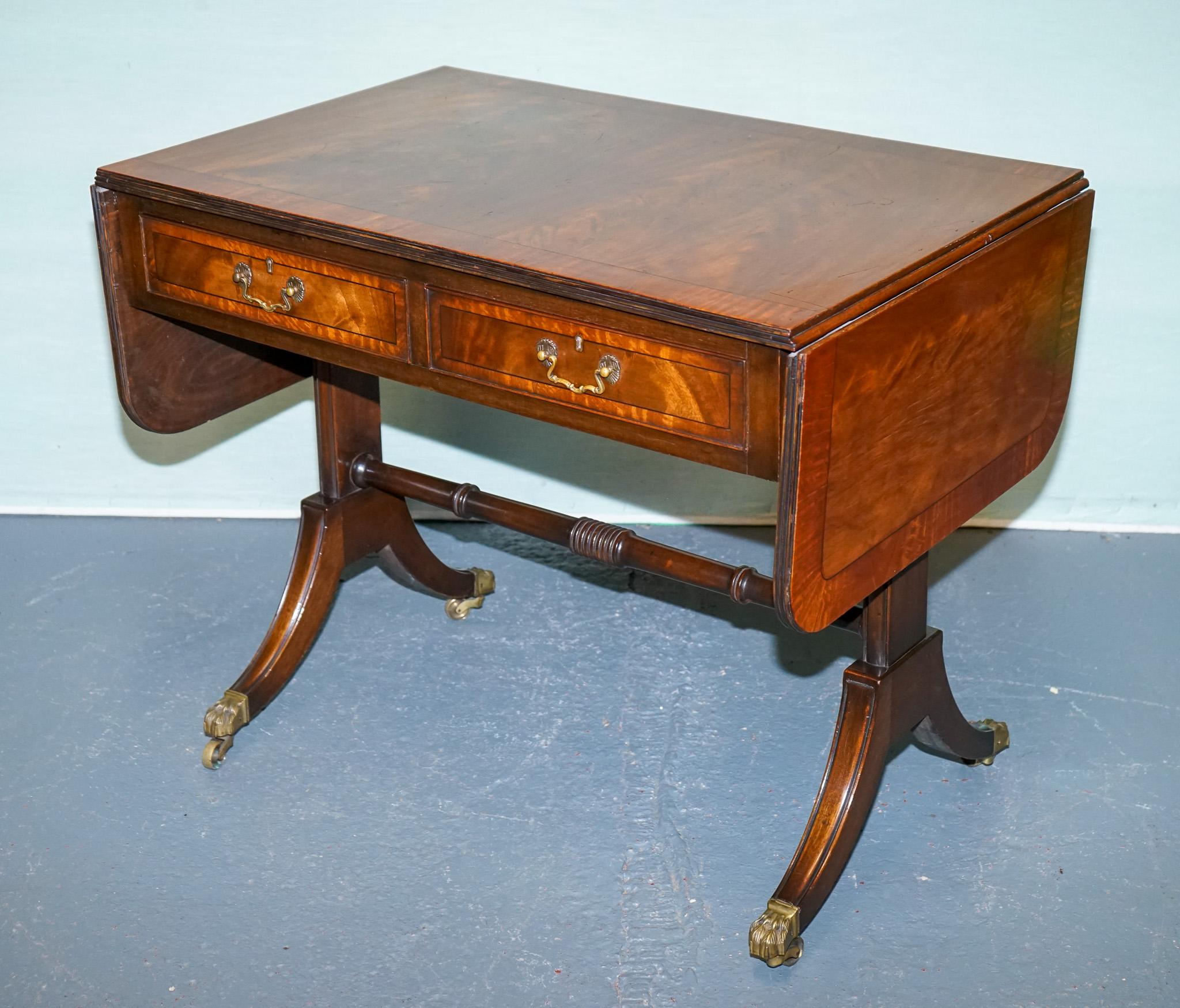 
Antiques of London



This elegant vintage drop-leaf sofa table showcases classic craftsmanship and timeless versatility. The richly grained top features two hinged leaves that extend the surface when needed, making it perfect for entertaining or