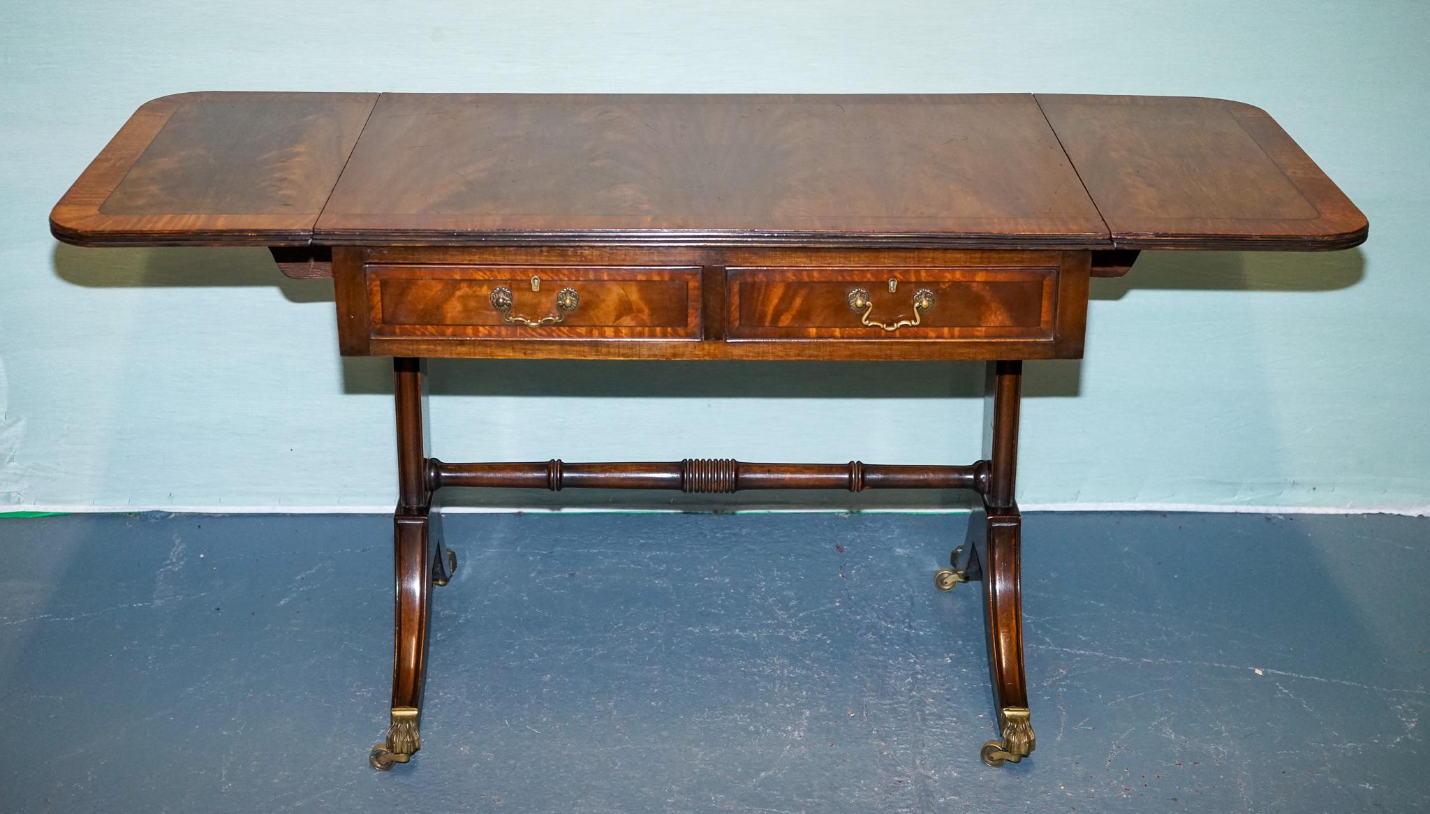 British VINTAGE HARDWOOD DROP LEAF SIDE TABLE WiTH SABER LEGS AND BRASS PAW FEET For Sale