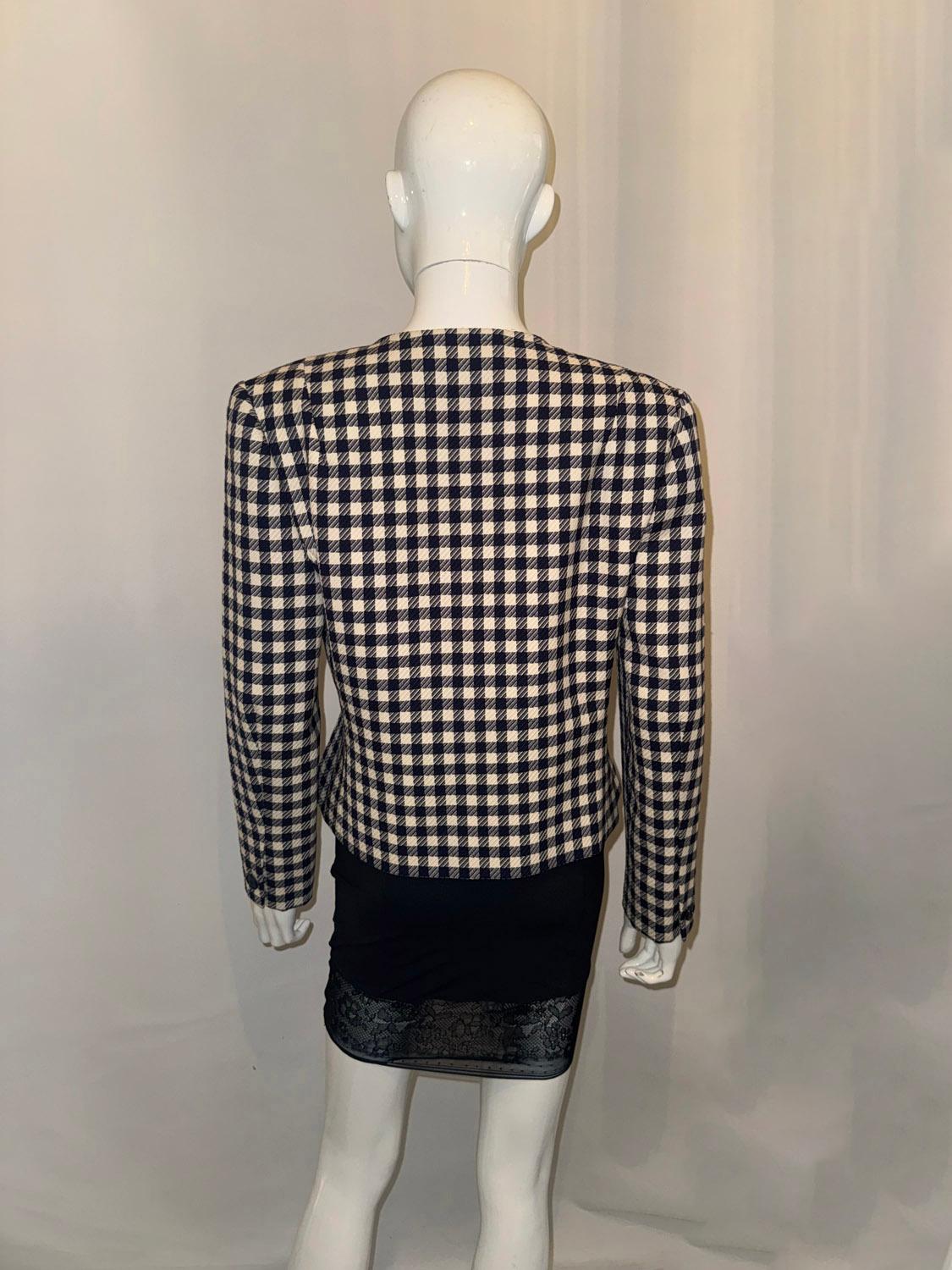 A chic vintage jacket by Hardy Amies, dressmaker to the late Queen Elizabeth. The jacket is in a blue and white check in a lovely textured fabric. It has one button on each cuff and three rows of two buttons on the front. It is collarless with with