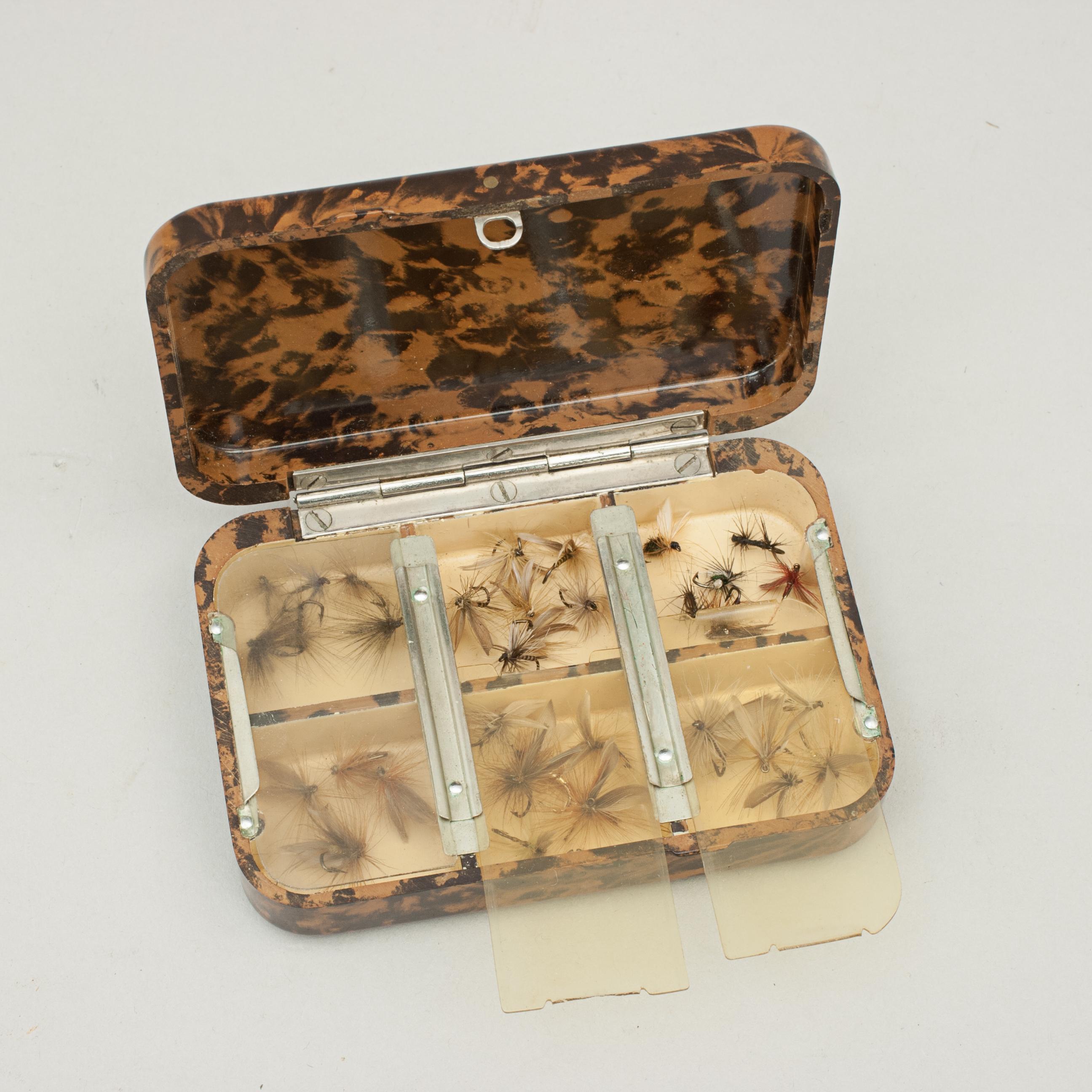 Vintage Small Hardy Bros. Neroda Trout Fly Box.
A good Neroda fly box made from bakelite with a brown tortoiseshell finish manufactured by Hardy's of Alnwick. The lid and bottom are embossed with 'Hardy BROS. LTD. MAKERS ENGLAND' and holding a