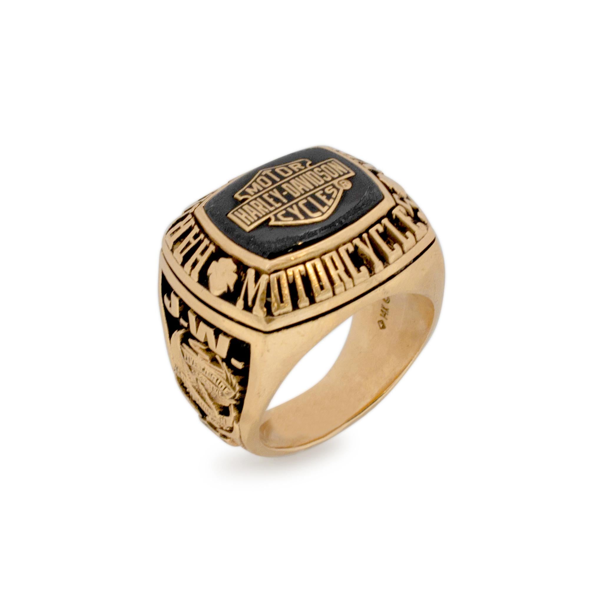 Brand: Harley Davidson

Gender: Mens

Metal Type: 14K Yellow Gold

Size: 10.5

Shank Width: 20.75mm tapering to 6.70mm

Weight: 37.40 grams

Men's designer made textured & polished 14K yellow gold, cocktail ring with a tapered shank. Engraved with