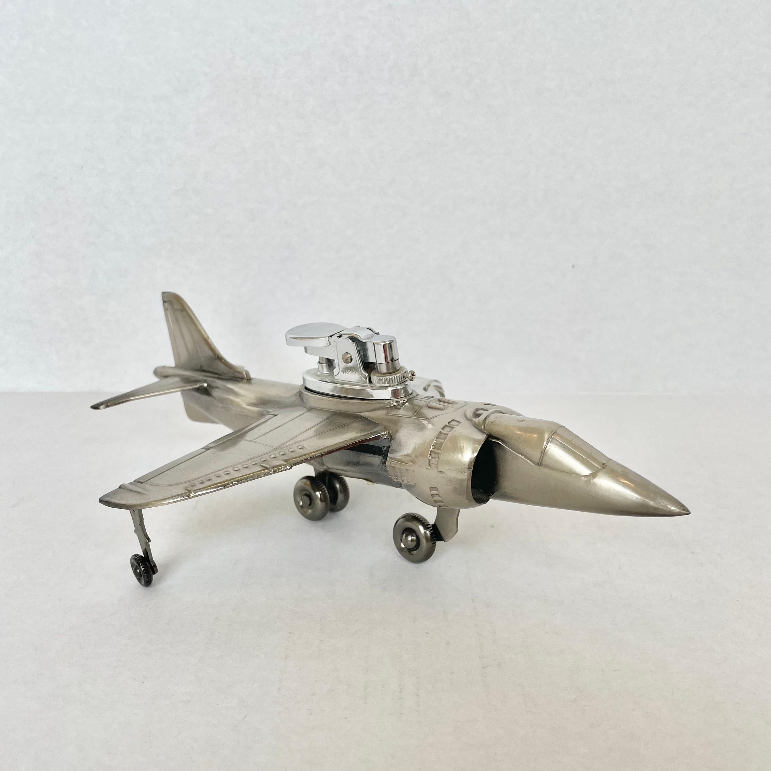 Cool vintage table lighter in the shape of a Harrier Jet. Made of metal with 