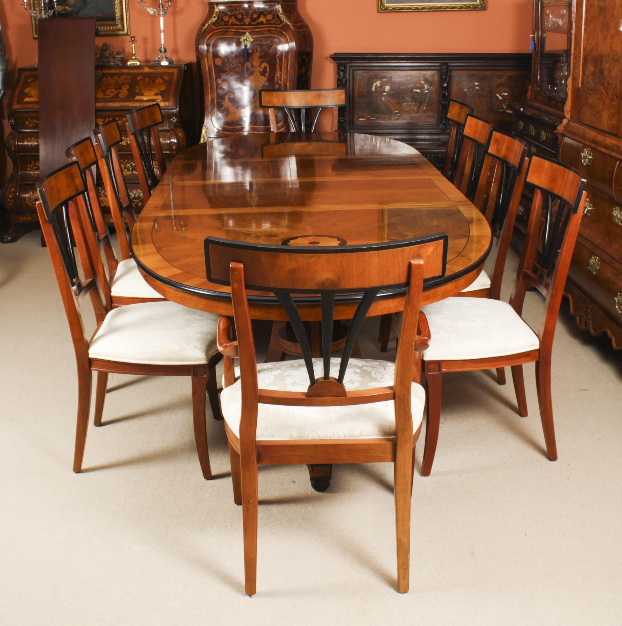 This is a fabulous high quality Biedermeier dining set comprising a satin birch twin pillar oval dining table and matching set of ten dining chairs, purchased at great expense from Harrods, Knightsbridge, London in the 1980s.

The oval satin birch