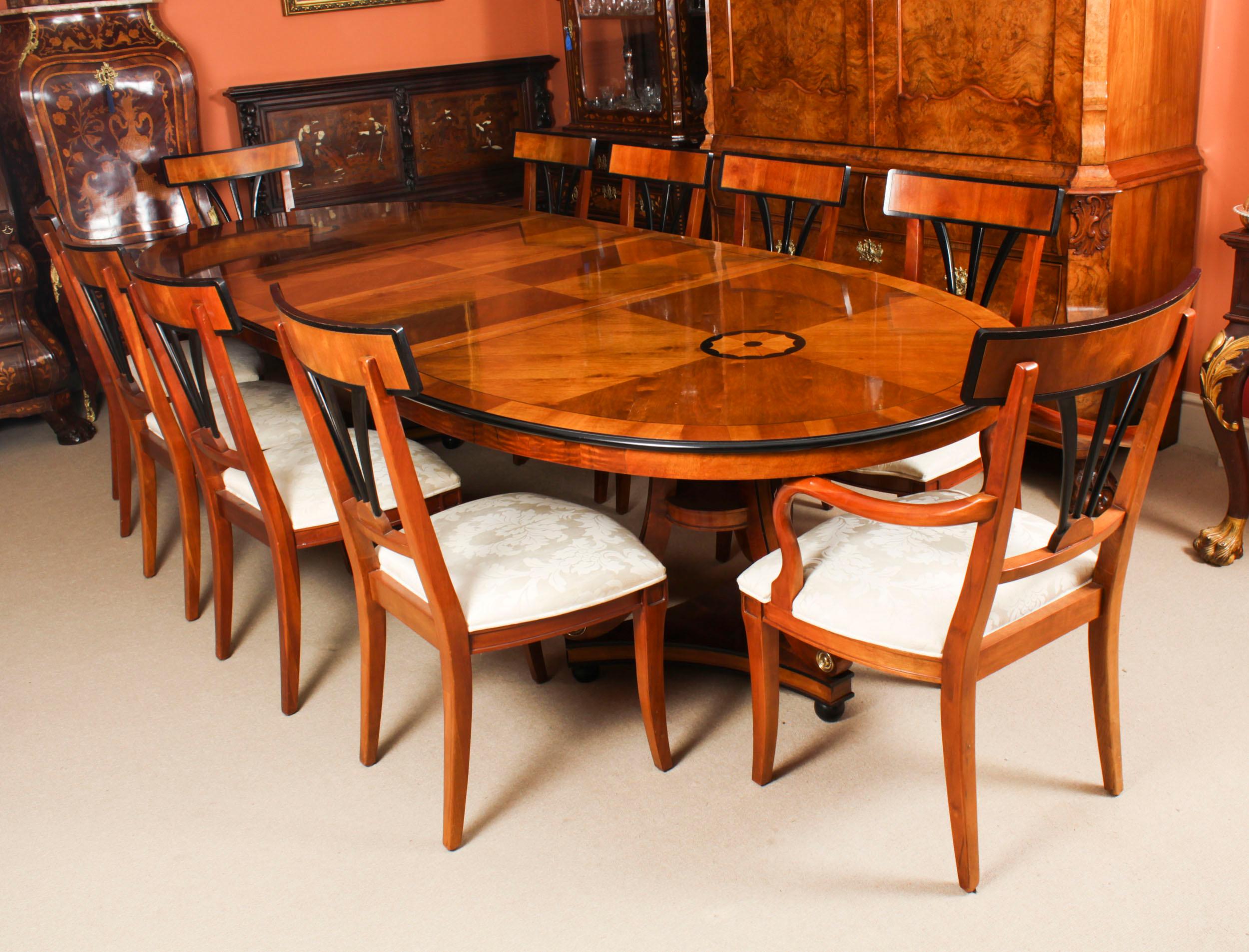 This is a fabulous high quality satin birch twin pillar oval dining table purchased at great expense from Harrods, Knightsbridge, London in the 1980s.

The oval top with inlaid circular satinwood and ebonised marquetry decoration at each end, with