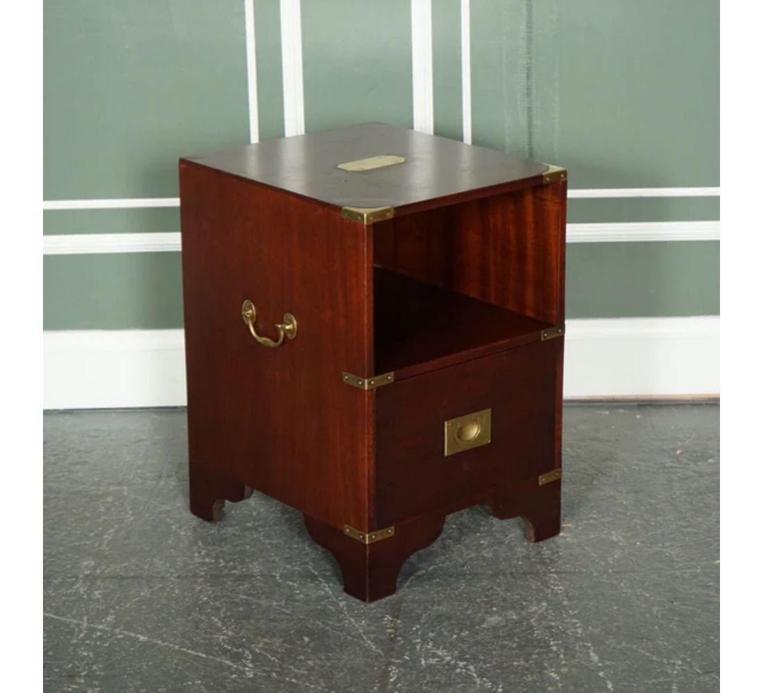 We are delighted to offer for sale this Lovely Nightstand with Brass Fittings and Military Campaign Side Table Drawers.

Made by R.E.H Kennedy and retailed through Harrods London, a beautiful and well-made table. Inspired by Kennedy's popular