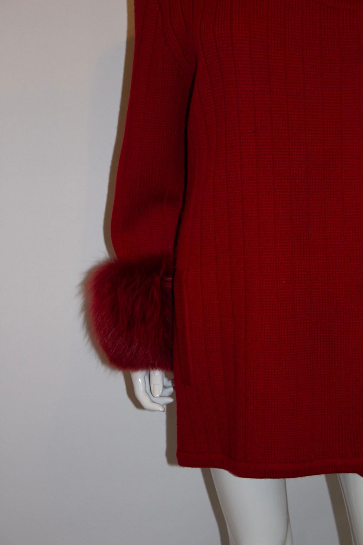 A headturning vintage red wool jacket by Harrods. In a  heavy wool knit, this jacket will keep you wonderfully warm and make a entrance. The red wool jacket is collarless, has large buttons , the original shoulder pads ( could be removed ) and red