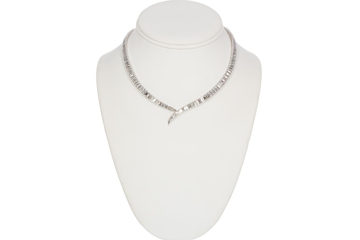 We are pleased to offer this Vintage Harry Winston Platinum Step Cut Diamond Riviere Line Necklace . This stunning necklace is fashioned from platinum and features a bezel set design with an estimated 20.99ctw E-F/VVS1-VVS2 baguette cut diamonds.