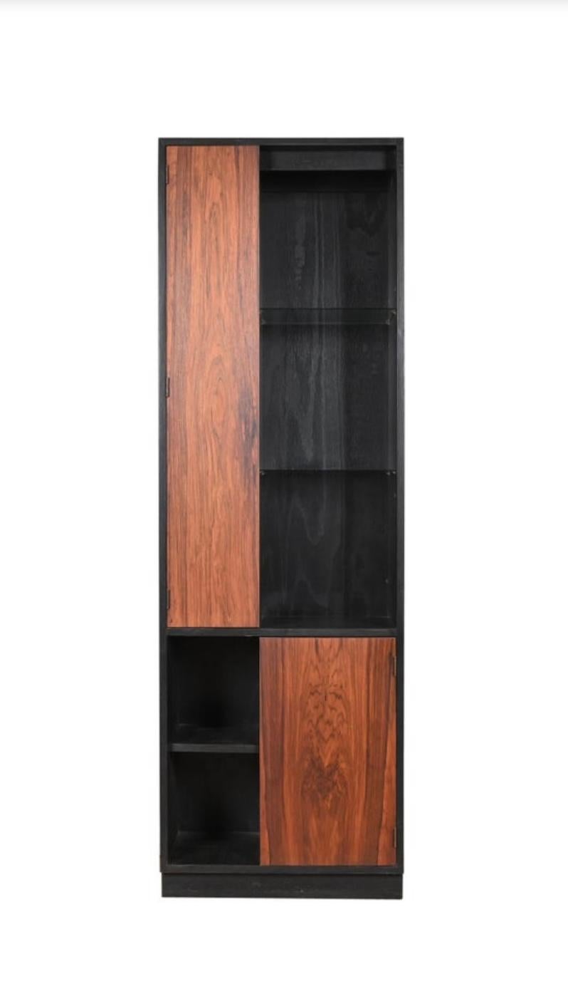 
Outstanding set of four rosewood and ebonized oak alternating door display cabinets /bookcase lighted with glass shelves designed by Harvey Probber circa 1960. Nice original condition. minor scratches and edge wear. Very unusual to find 4 matching