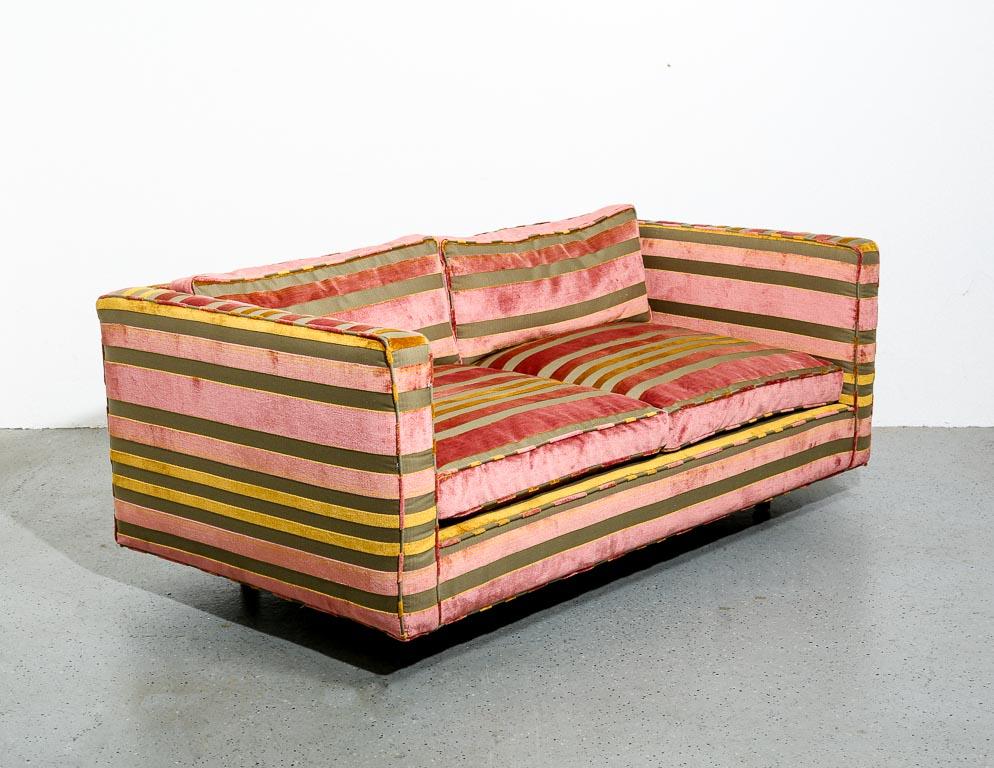 Vintage settee designed by Harvey Probber. Newly upholstered in period-correct velvet striped fabric of gold, pink, and olive. Floats over solid walnut legs. Signed by the manufacturer on upholstery tag.