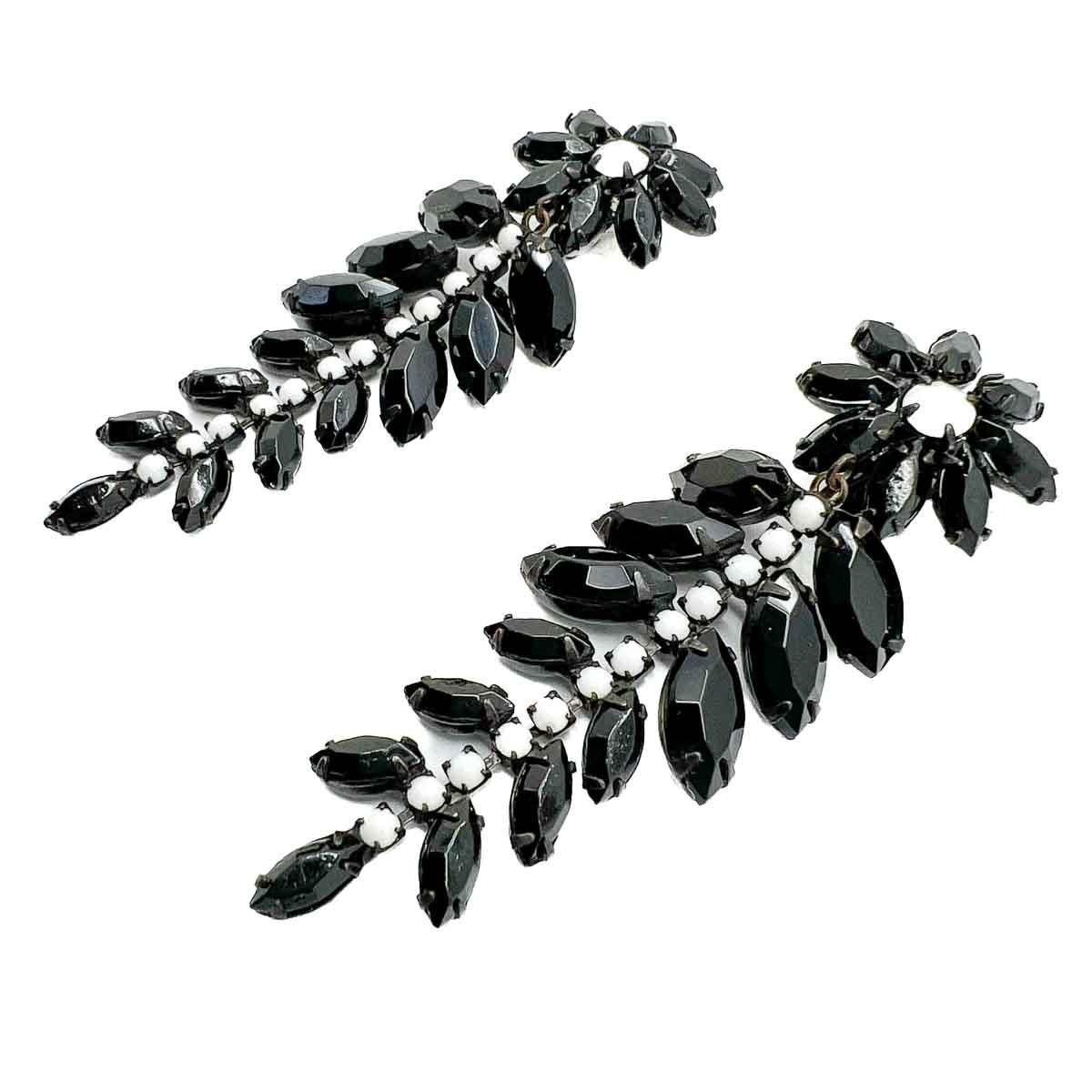 A pair of Vintage Hattie Carnegie Monochrome Drop Earrings. Timeless black and white fancy cut glass drops finished with a wonderfully chic floral motif. A fabulous find from the exquisite House of Hattie Carnegie.

When Hattie Carnegie left Austria