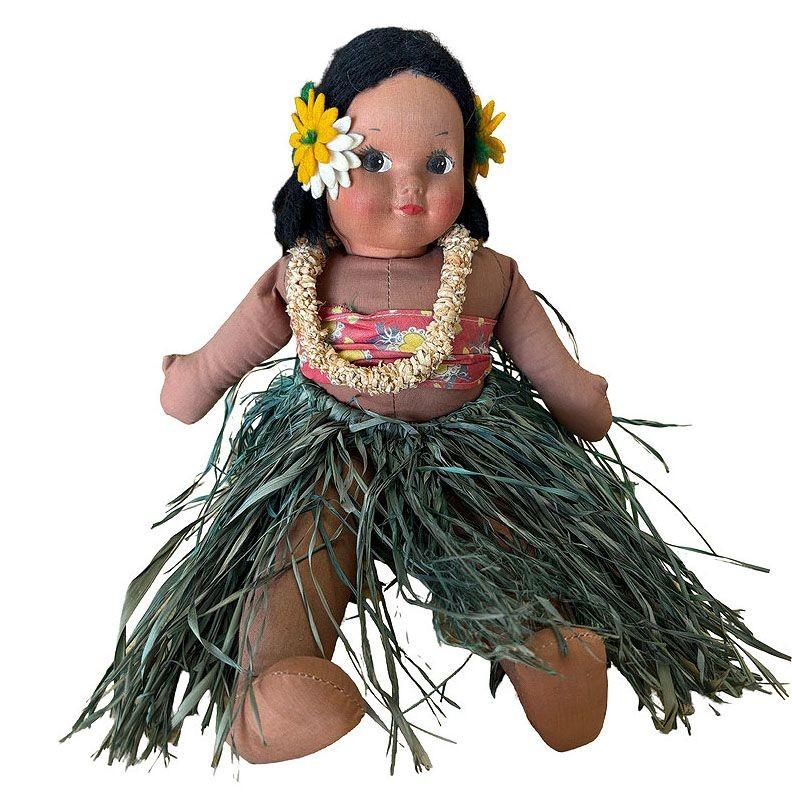 Original handmade post-war Hawaiian cloth Hula Doll with a soft cloth body, the doll features a hand-painted face with sweet, playful expressions, evoking the innocence of a baby girl. Dressed in a traditional hula outfit with a raffia grass skirt