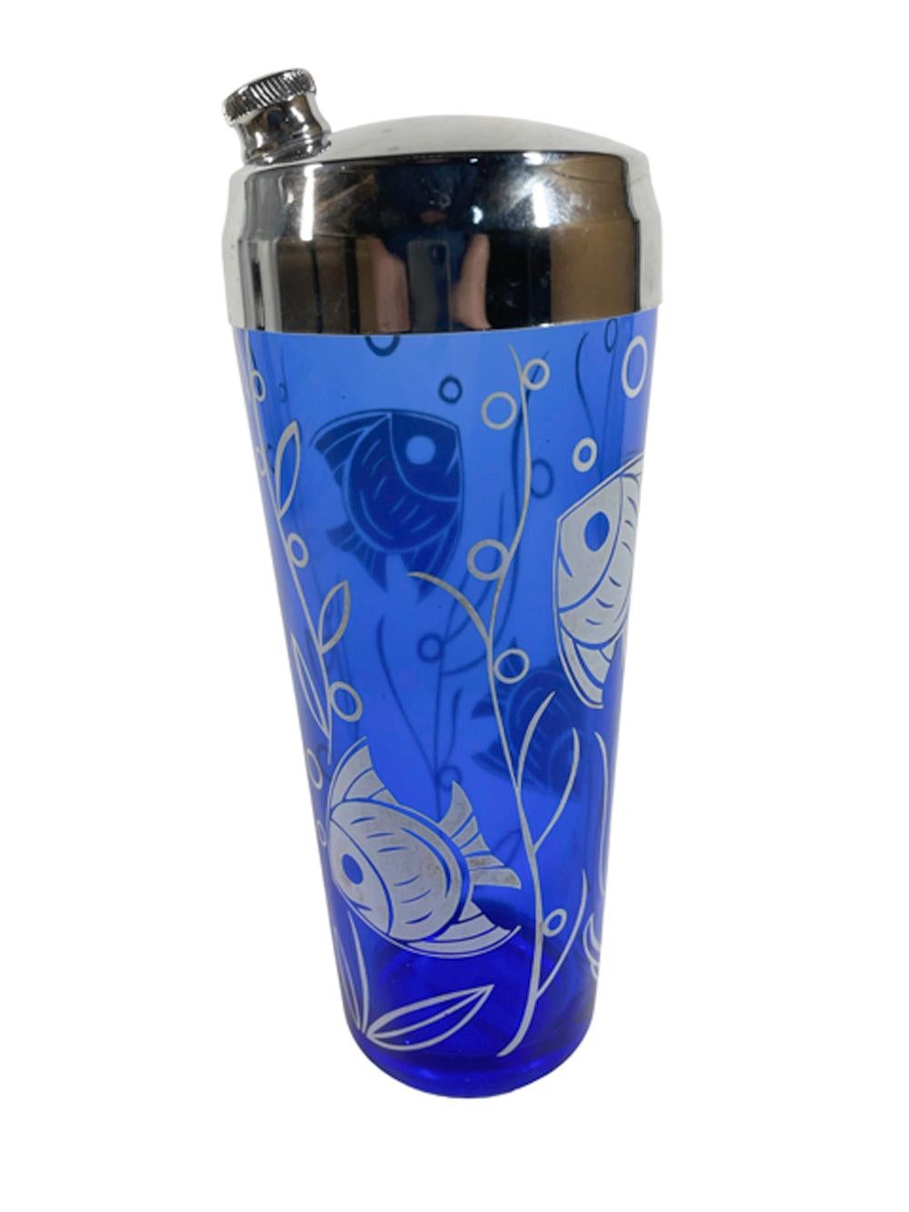 Art Deco blue glass cocktail shaker by Hazel-Atlas from the Sportsman Series and decorated in white with tropical fish, bubbles and seaweed. Topped with a chrome lid with twist-off spout cap and integral strainer.