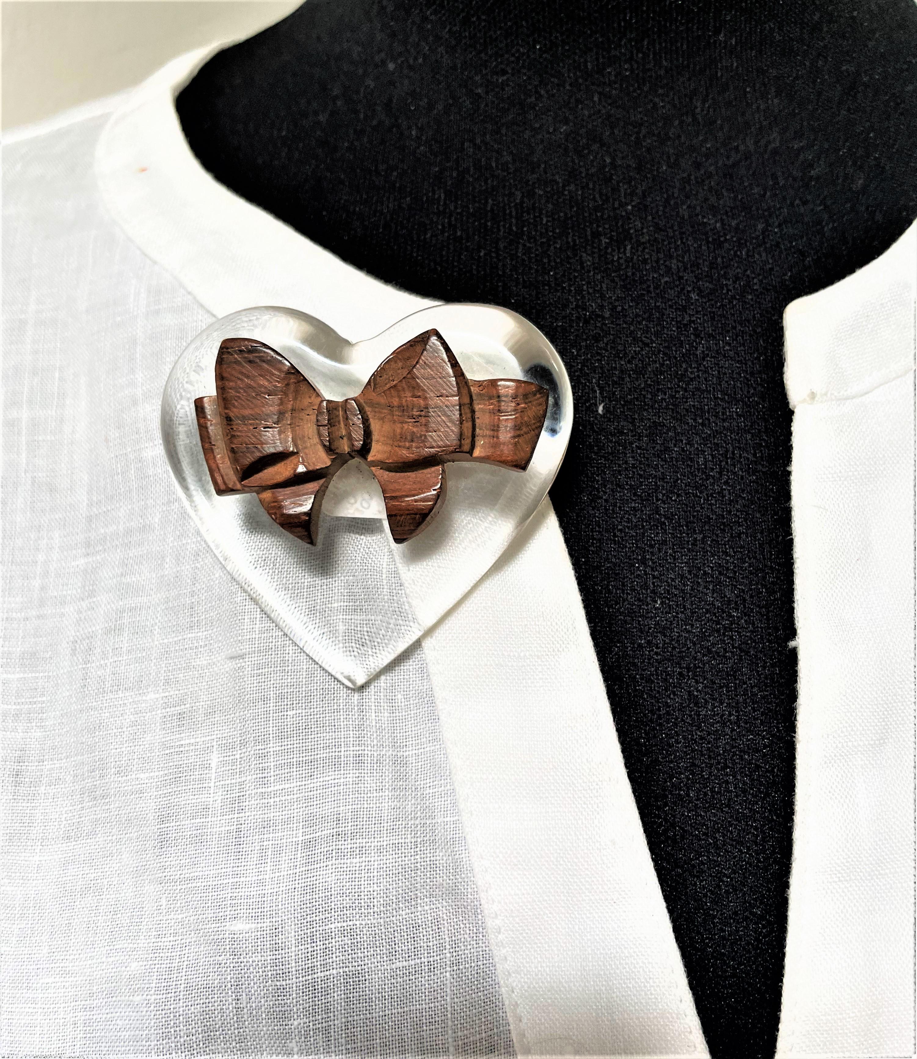 Women's or Men's Vintage heart brooch made by lucite decorated with a bow made of wood, 1930s USA For Sale