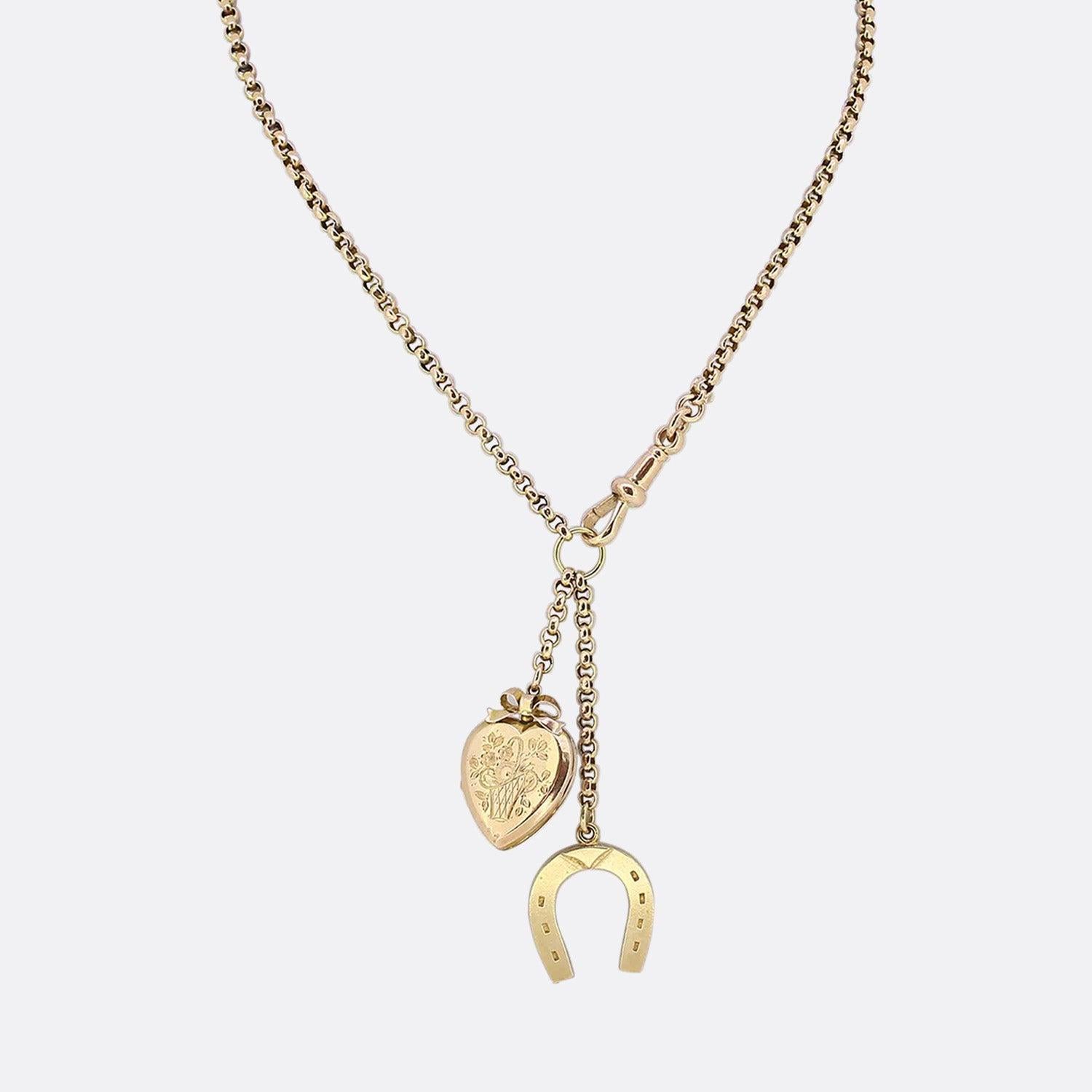This is a vintage 9ct yellow gold belcher chain charm necklace. The necklace features two pendants; one is an engraved heart shaped locket and the other is a 9ct gold horseshoe. The necklace is securely attached by an antique swivel clasp.