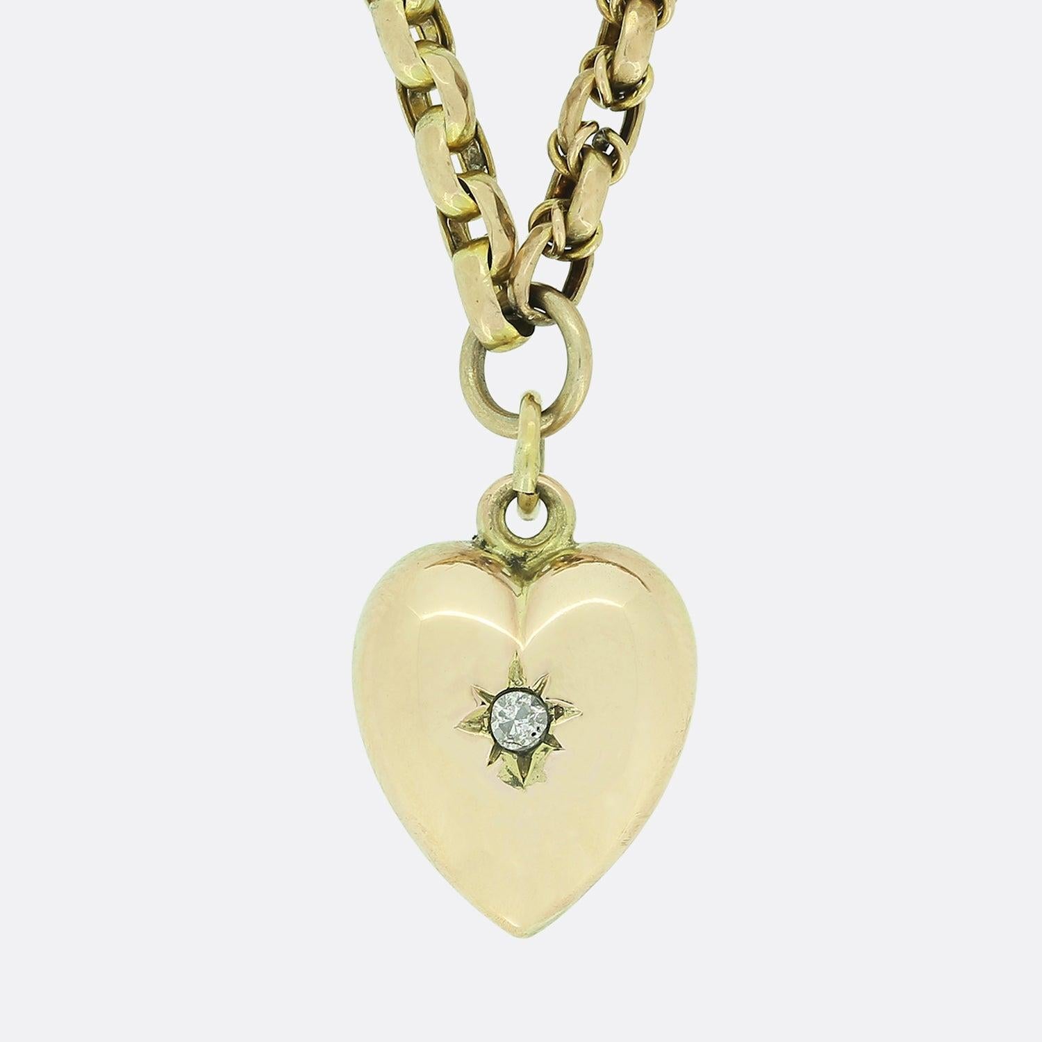 This is a vintage 9ct yellow gold belcher chain charm necklace. The necklace features five heart pendants; all of which have been set with either a diamond, turquoise or a pearl. The necklace is securely attached by an antique swivel clasp.