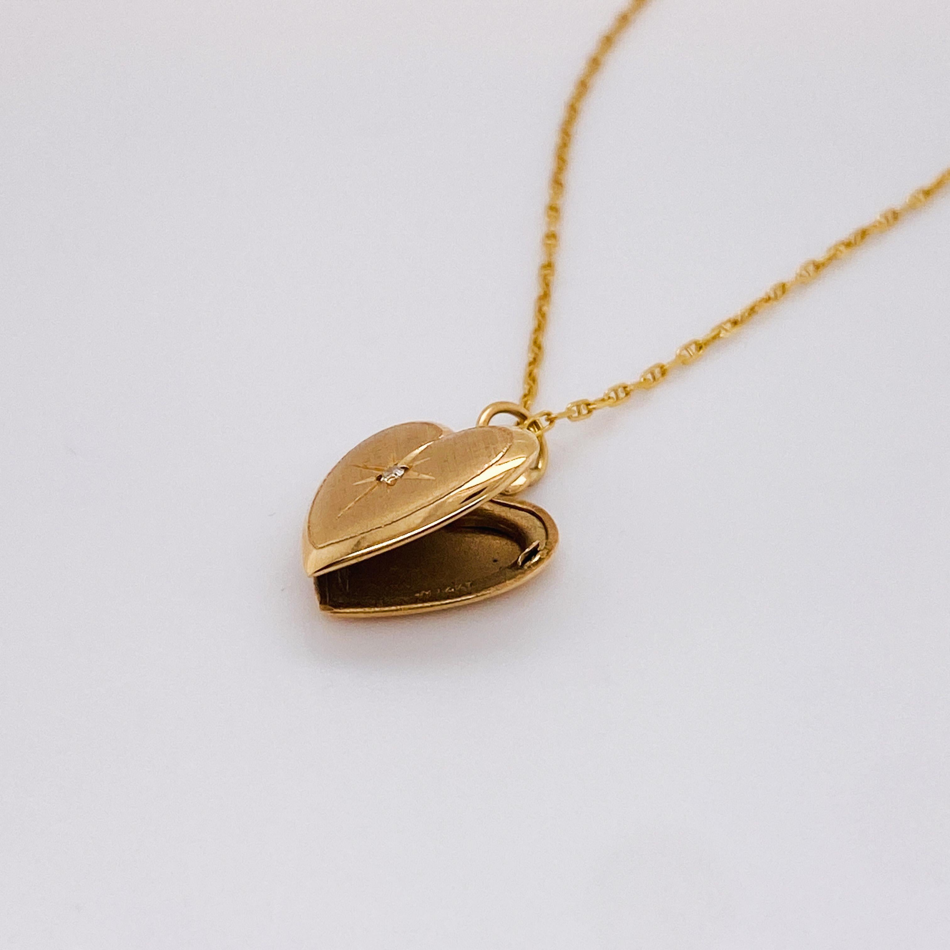 This vintage heart locket pendant and chain is perfect to cradle your love to your heart. The locket can hold two small photos or a tiny treasure inside. The locket and chain are entirely 14 karat gold. The front of the locket has a cross Florentine