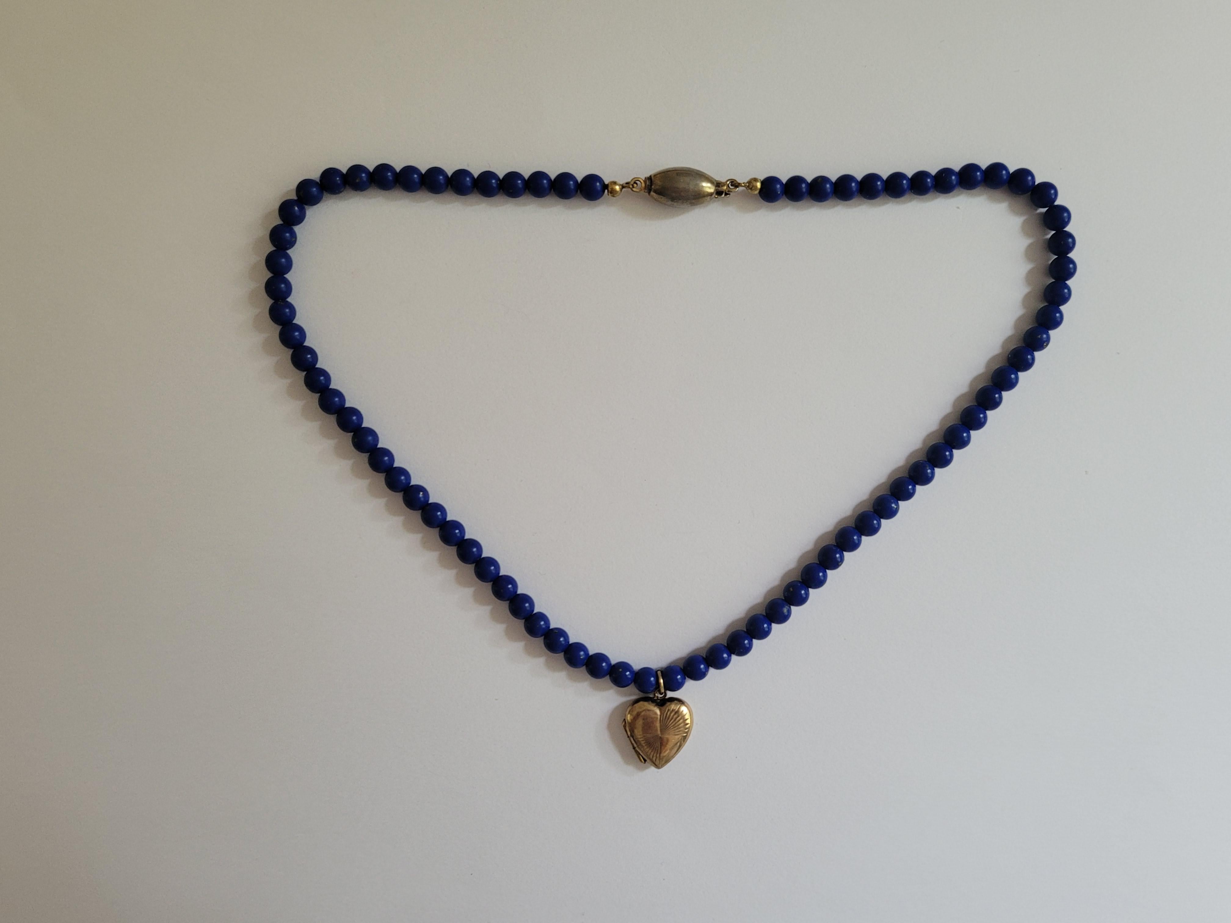 A Lovely Vintage 9 Carat Gold Back and Front locket on Lapis Lazuli beads necklace. One of a kind necklace and looks lovely when worn. English origin locket and Continental beads necklace.
Width of the locket 14mm.
Length of the necklace including