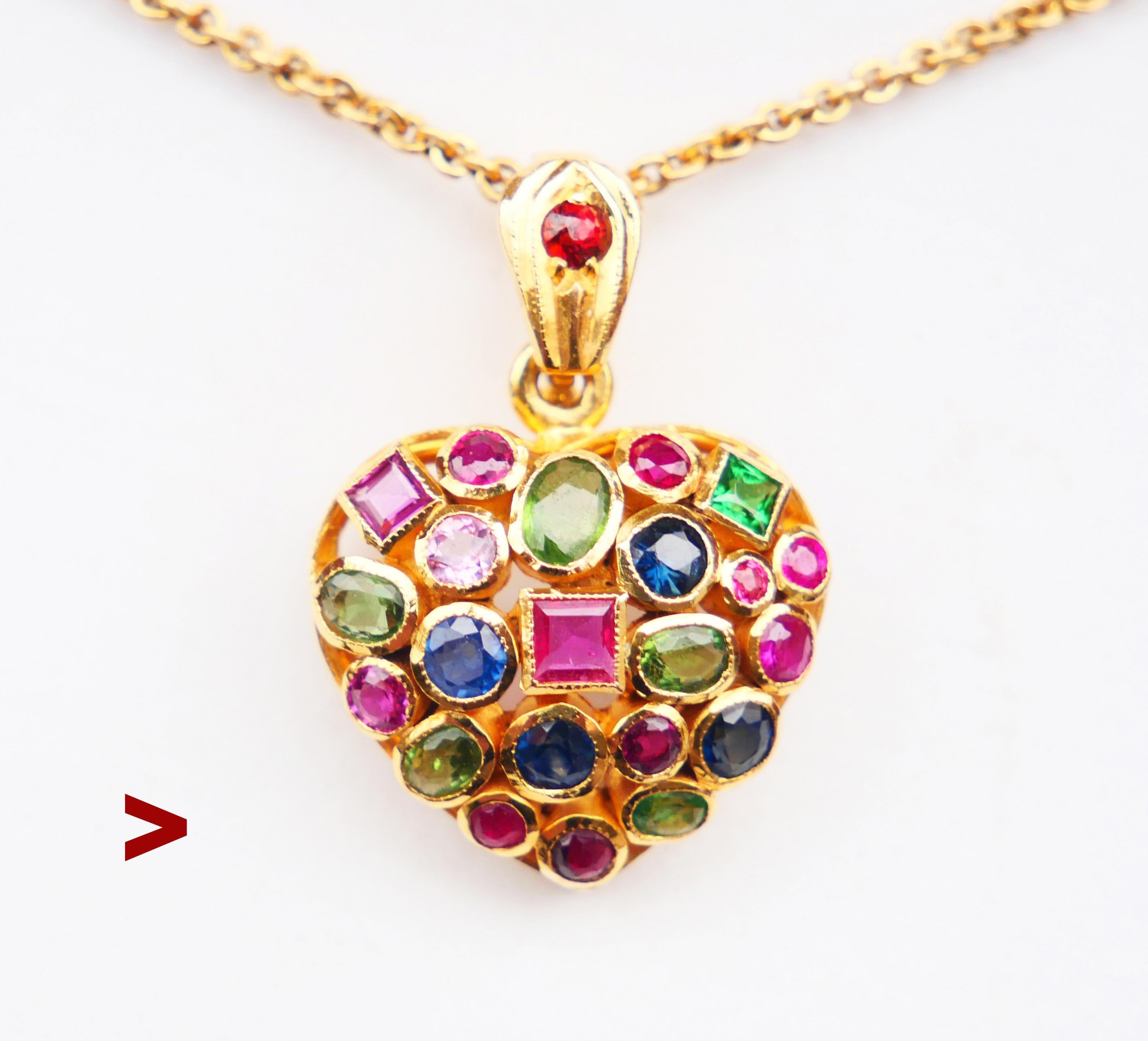Vintage hand - made Heart Locket in solid 18K Gold decorated with 23 natural gem stones cut in various shapes : Rubies, Sapphires, Tourmalines and one Red Garnet.
Origin unknown, no hallmarks ,metal tested solid 18K Yellow Gold. Measures 23 mm long