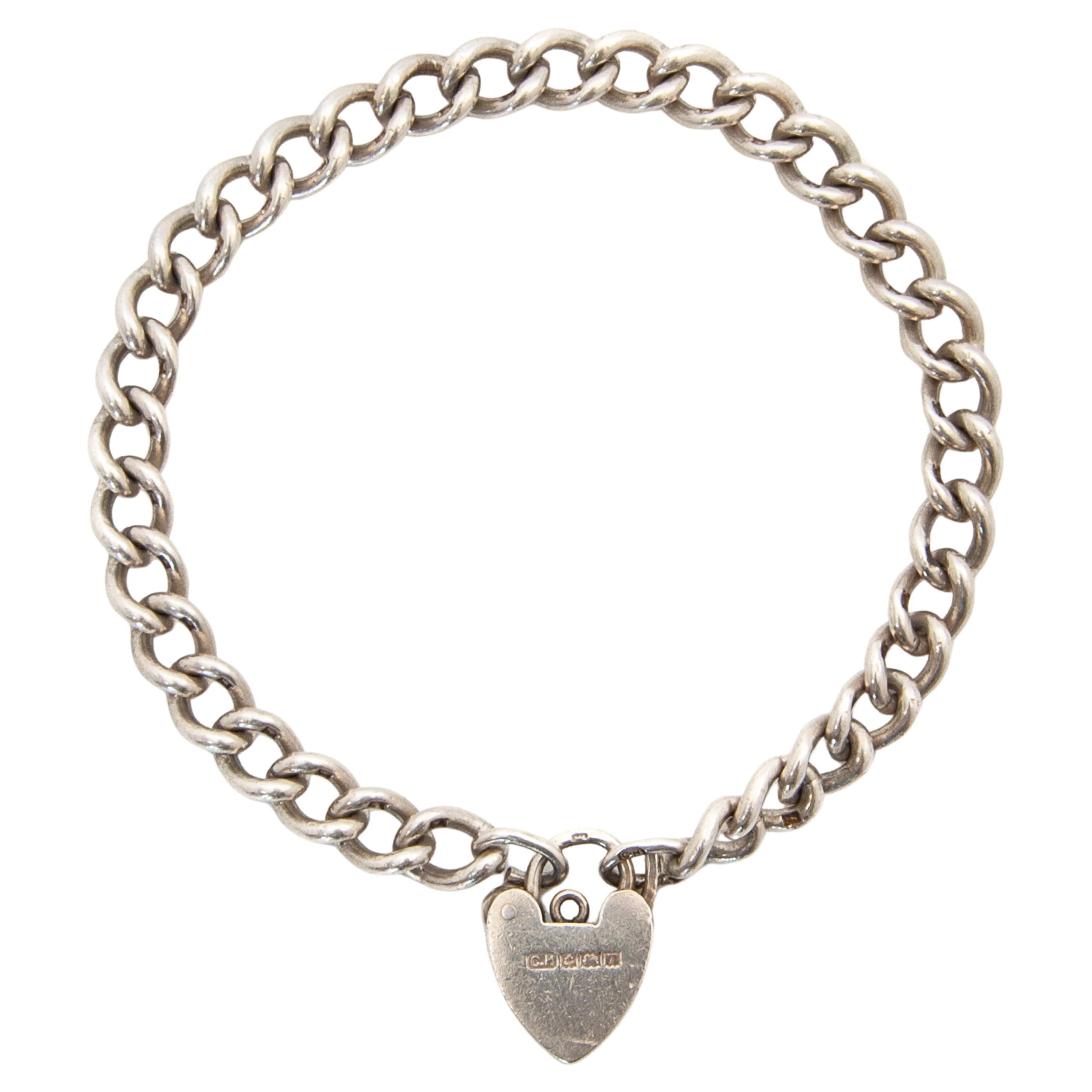 This is a beautifully crafted, high quality Charles Horner (1837–1896) sterling silver curb chain charm bracelet with a heart padlock clasp. The bracelet links are stamped with a lion passant for sterling silver and stamped on the end rings and