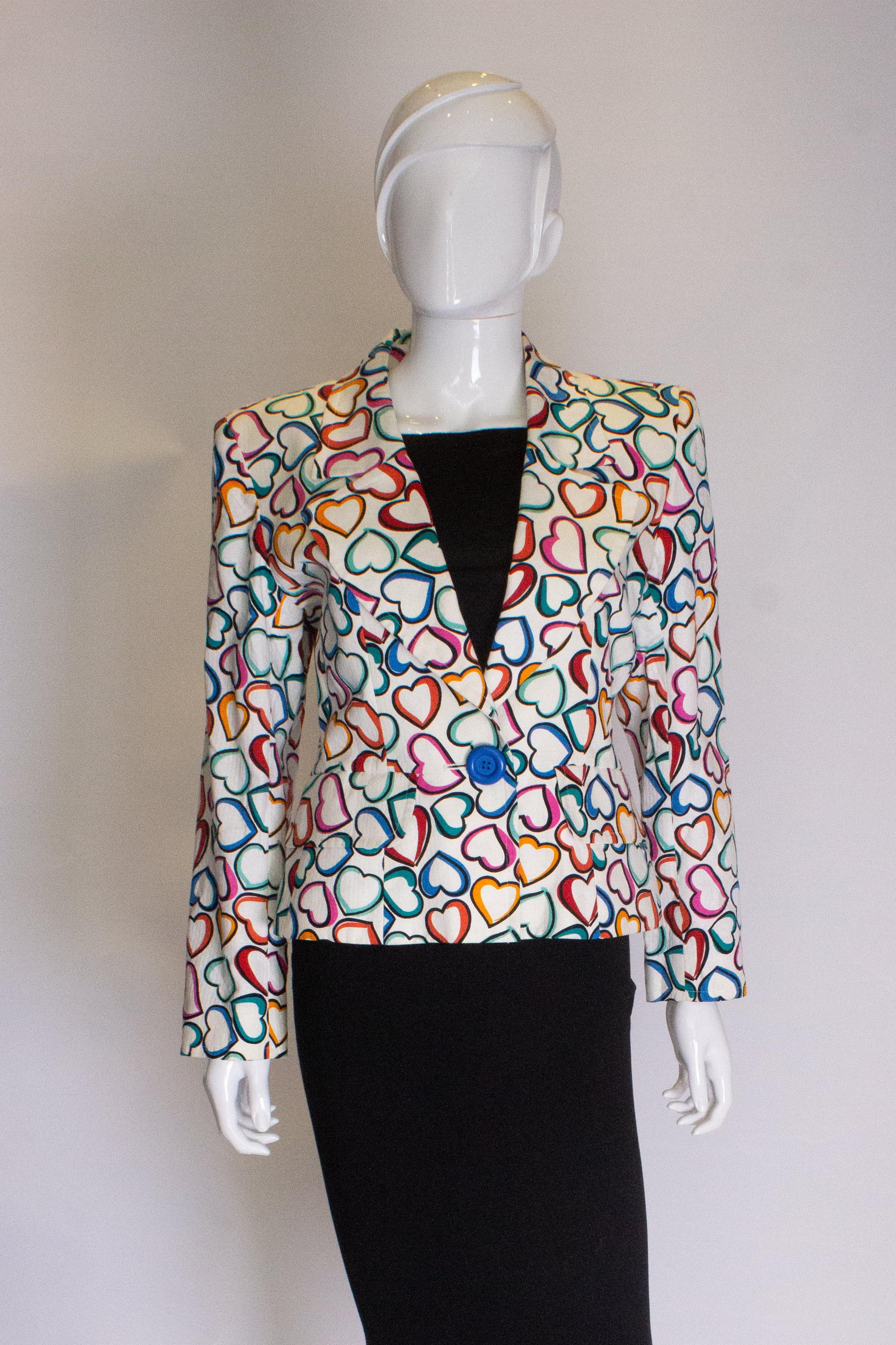 A fun jacket for Spring/Summer by Yves Saint Laurent. The cotton jacket has a multicoloour heart print with a one button opening and two front pockets. It has a button on each cuff and is fully lined.