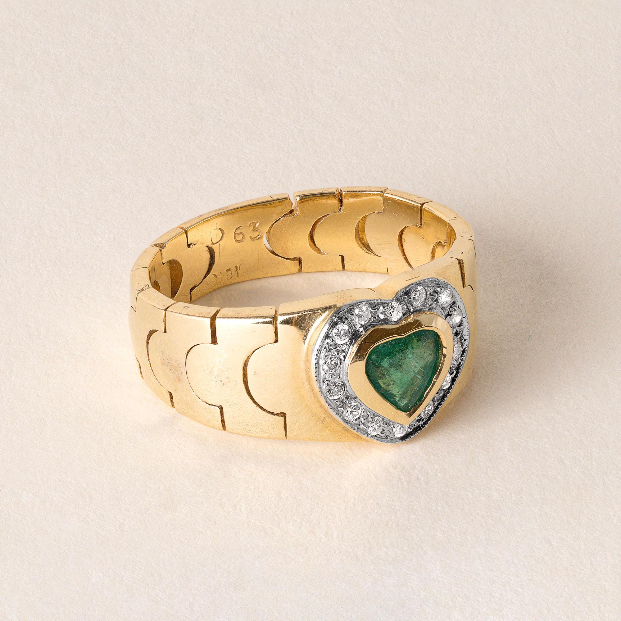 ~0.25 carat emerald heart shape bezel set in 18k gold ring
14 round brilliant diamonds pave set
F-G VS2
7 grams
Mesh gold chain link band
Ring size 6.25
8.3 widest point tapering down to 5mm
Circa 1980's