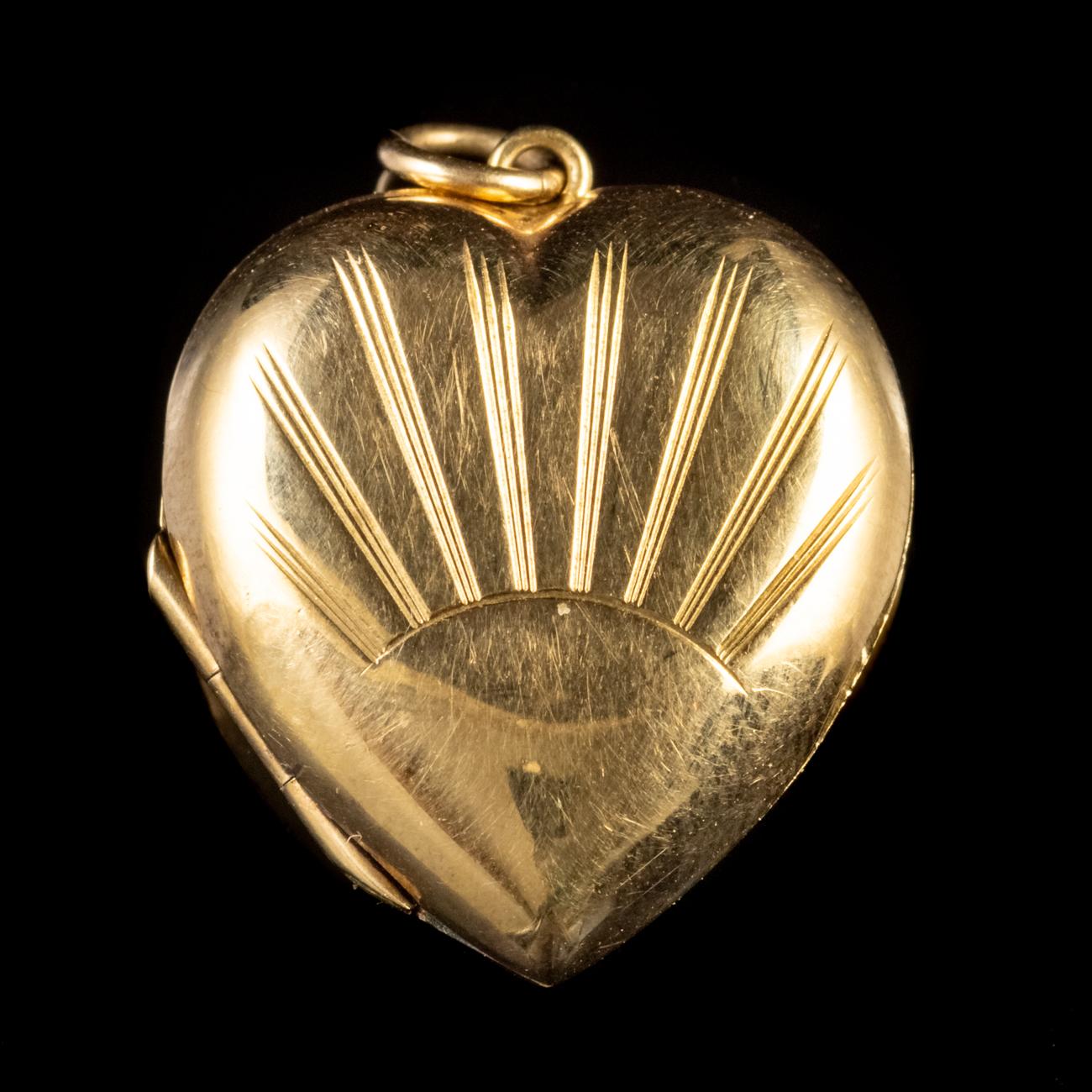 This beautiful Vintage locket has been commissioned in 9ct Yellow Gold front and back. It features a beautiful engraving of a sunrise on the front with sunbeams extending upward.

Hearts were a popular motif concerning lockets and of course