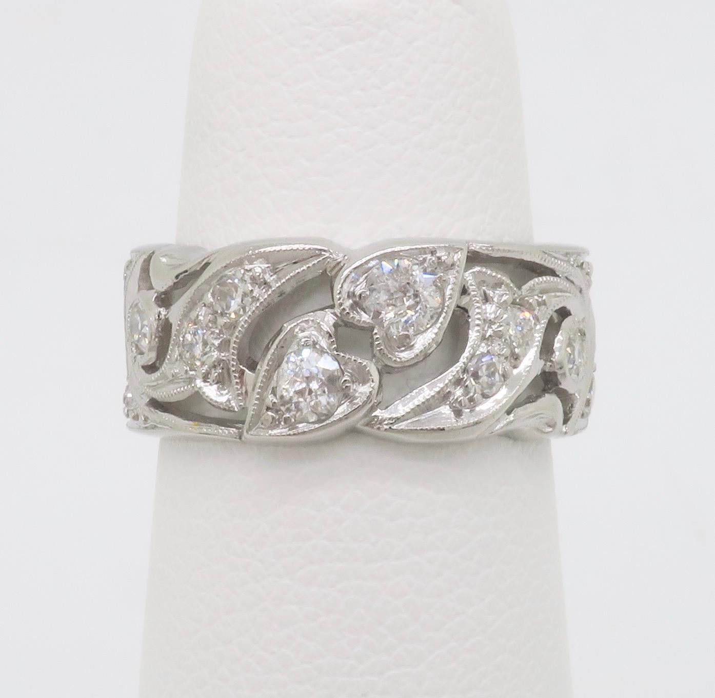 Vintage heart themed diamond eternity band made in Platinum. 

Diamond Cut: Old European Cut, Circular Brilliant Cut
Total Diamond Carat Weight: 0.85CTW
Average Diamond Color: F-H
Average Diamond Clarity: VS-SI
Metal: Platinum
Ring Size: 5 - not