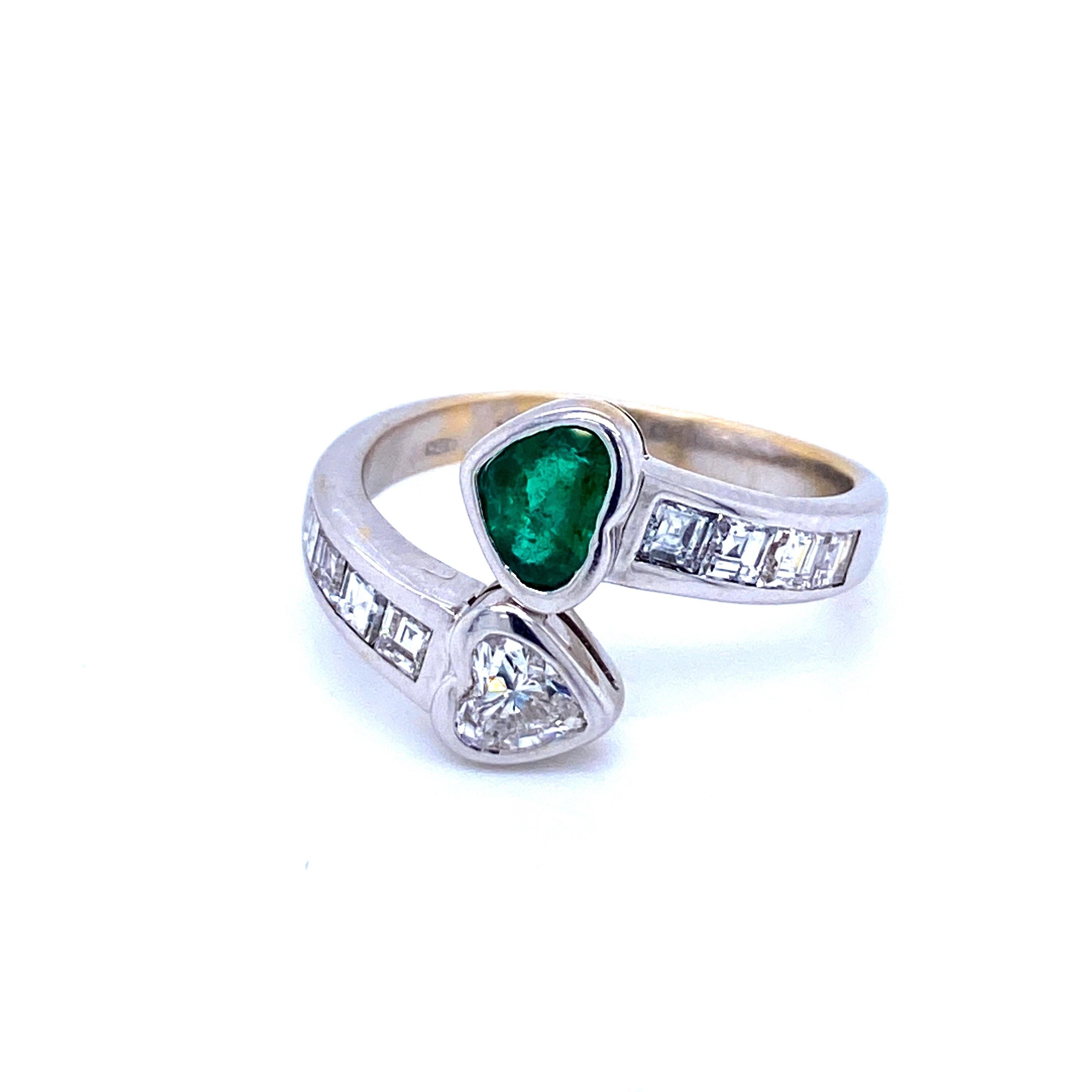 Beautiful and unique 18k white gold 'Vous et Moi' ring set with a Beautiful heart cut fine Colombian Emerald weighing 0.60 carat, and one sparkling heart Cut Diamond weighing 0.60 carat, graded F color Vvs1 clarity, surrounded by eight baguette