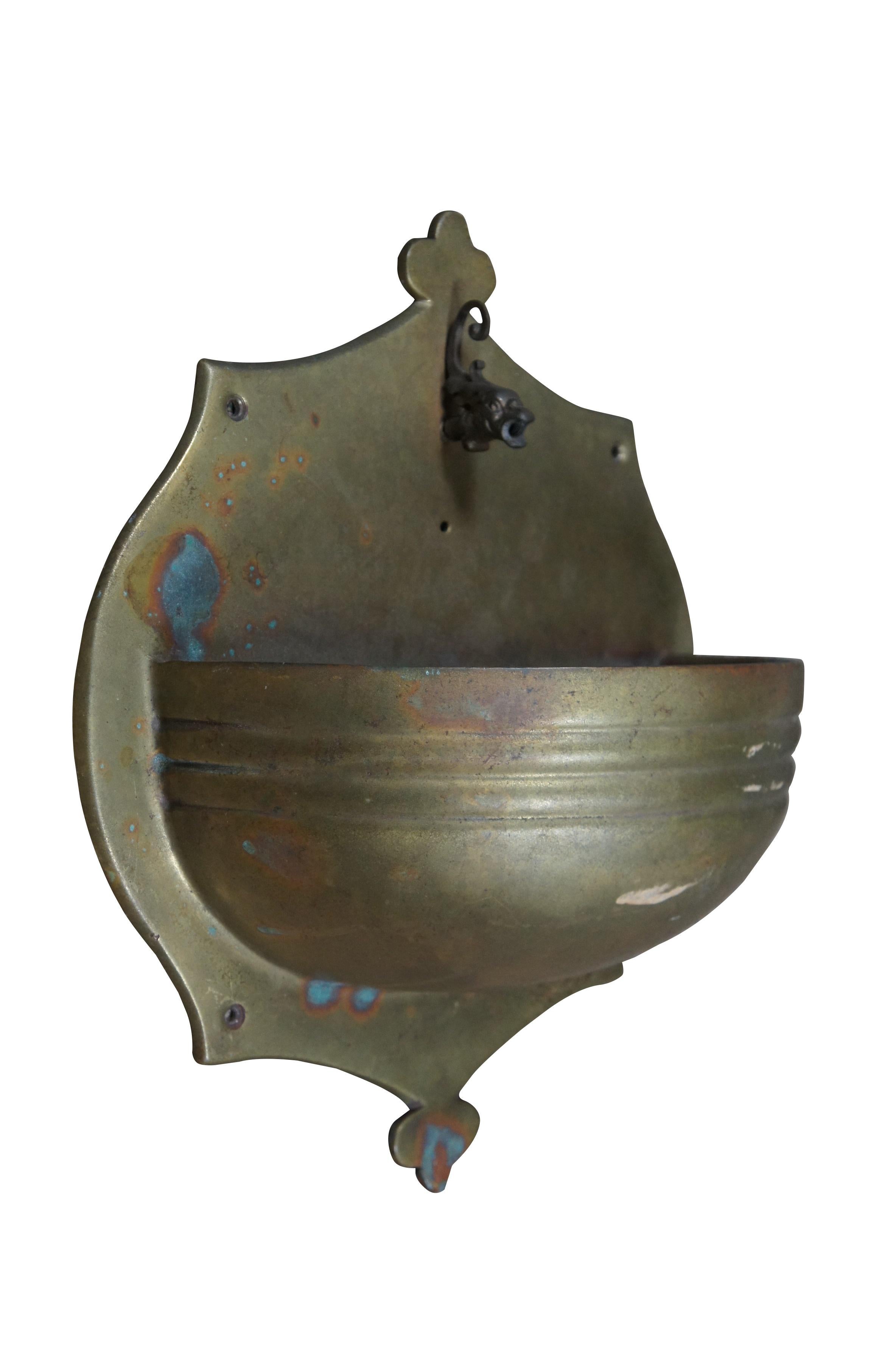 20th century solid brass European wall mounted lavabo / fountain with a spout in the shape of the head of a dolphin / fish with swirling head feathers and open mouth. Very Heavy.

Dimensions:
15.5
