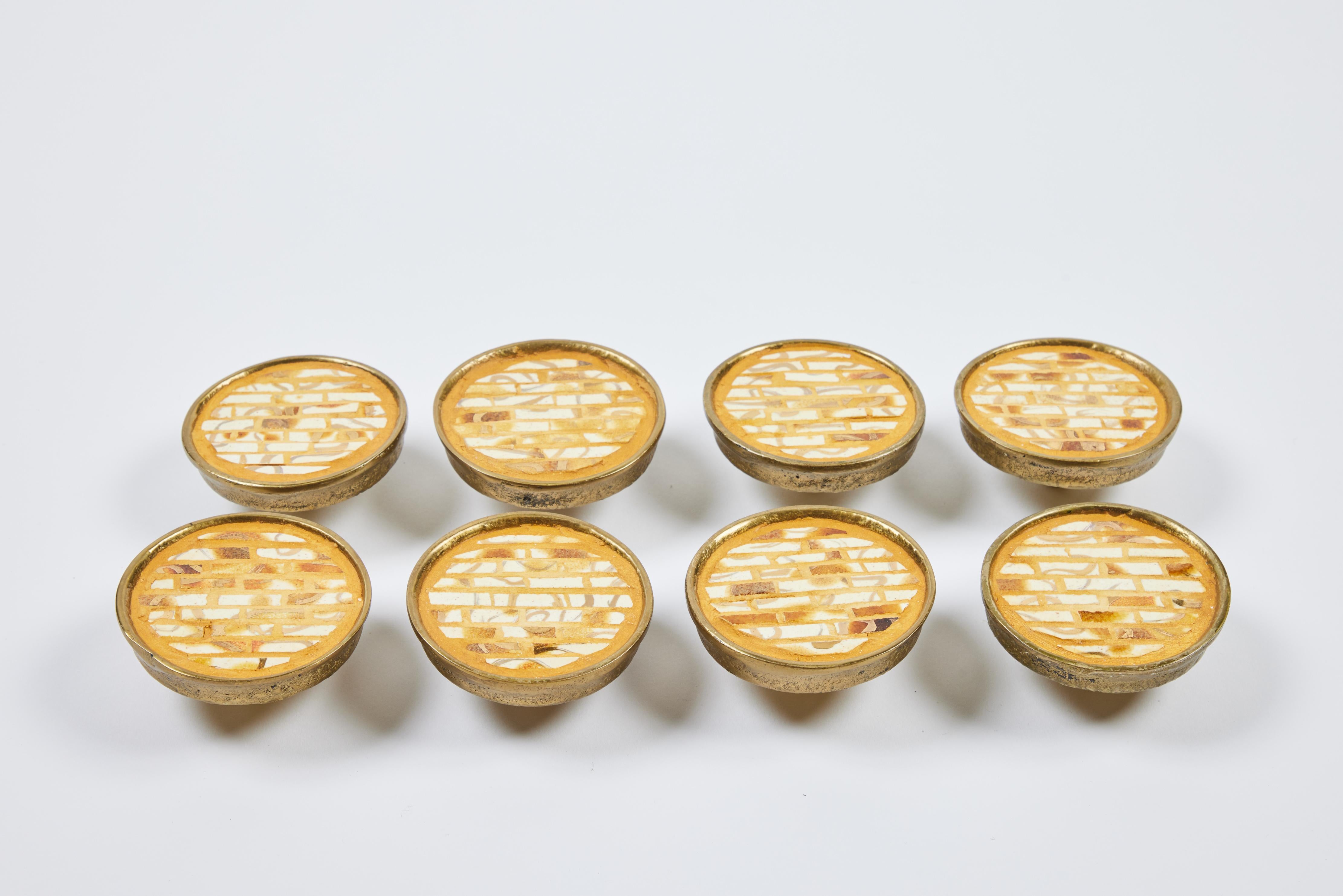 Check out this alluring set of 10 large heavy textured brass round drawer/cabinet pulls that were made in Mexico. They are inlaid with a beautiful white and gold glazed tile mosaic and will certainly be the the accent attraction to any door or piece