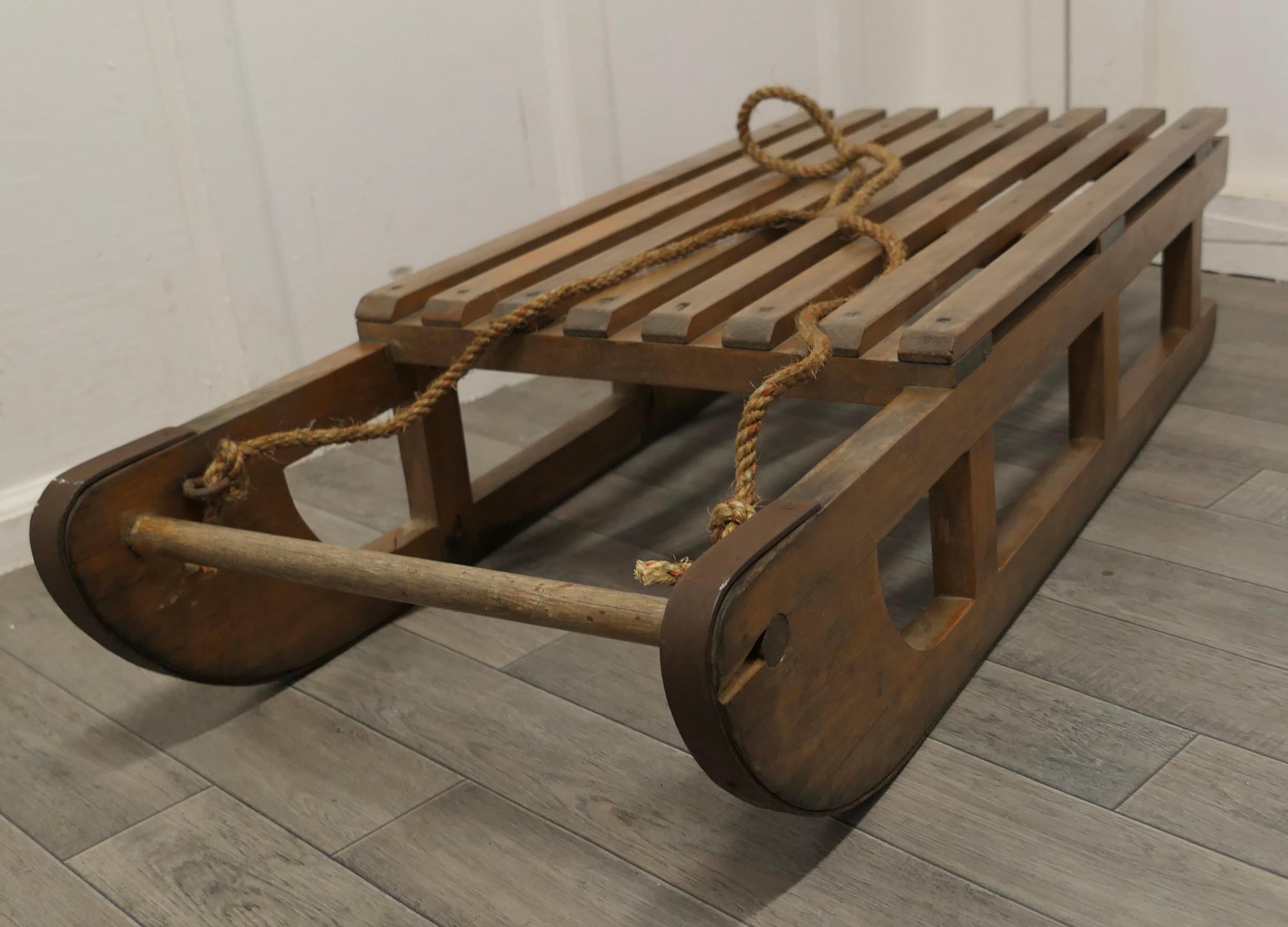Vintage heavy quality Alpine Sledge in beech.

This is a great piece fully working or for display, it has iron runners and an old sisal rope.
The sledge is 10” high, 43” long and 18” wide.
TJK273