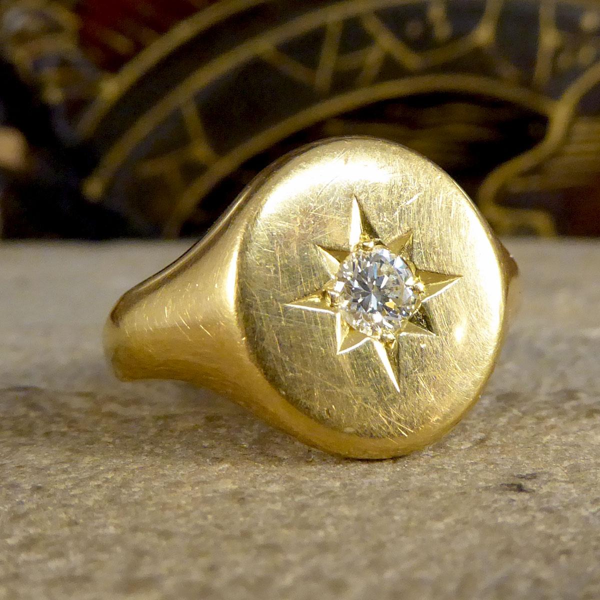 This solid Gold signet ring is oval faced with a star set Diamond in the centre weighing 0.25ct and being clear and bright. The ring has a heavy quality to it weighing 11.8g and fully crafted from 18ct Yellow Gold with an ovaled shape to it. A
