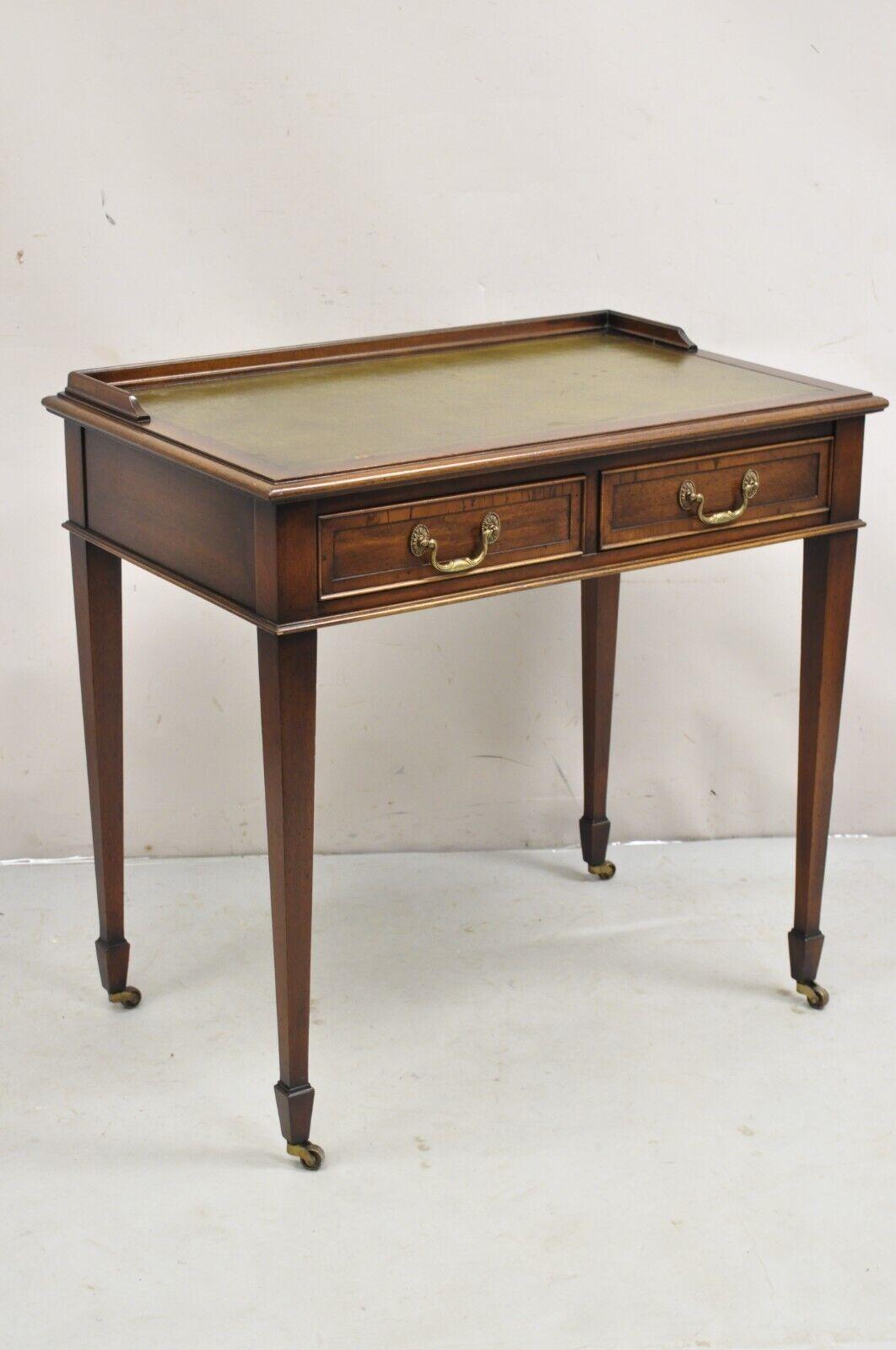 Vintage Hekman Edwardian Style Small Green Leather Top Mahogany Writing Desk. Item featured is a nice smaller size, 2 drawers, brass rolling casters, green tooled leather top, original stamp, quality American craftsmanship. Circa Mid 20th Century.