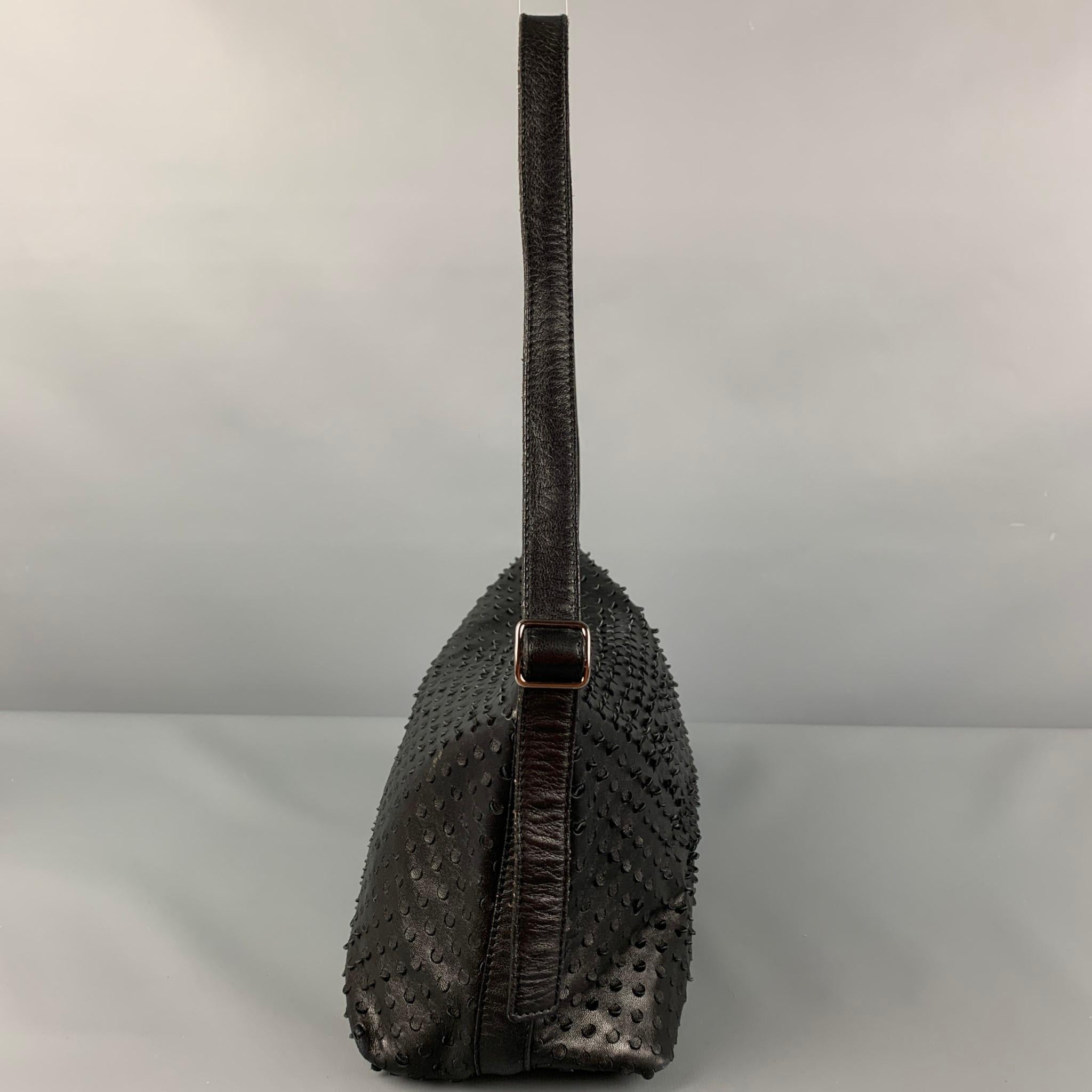 Vintage HELMUT LANG bag comes in a black perforated leather featuring a top handle, inner pocket, and a top zipper closure. Made in Italy. 

Good Pre-Owned Condition. Light wear at handle. As-Is.

Measurements:

Length: 9 in.
Width: 3.5 in.
Height: