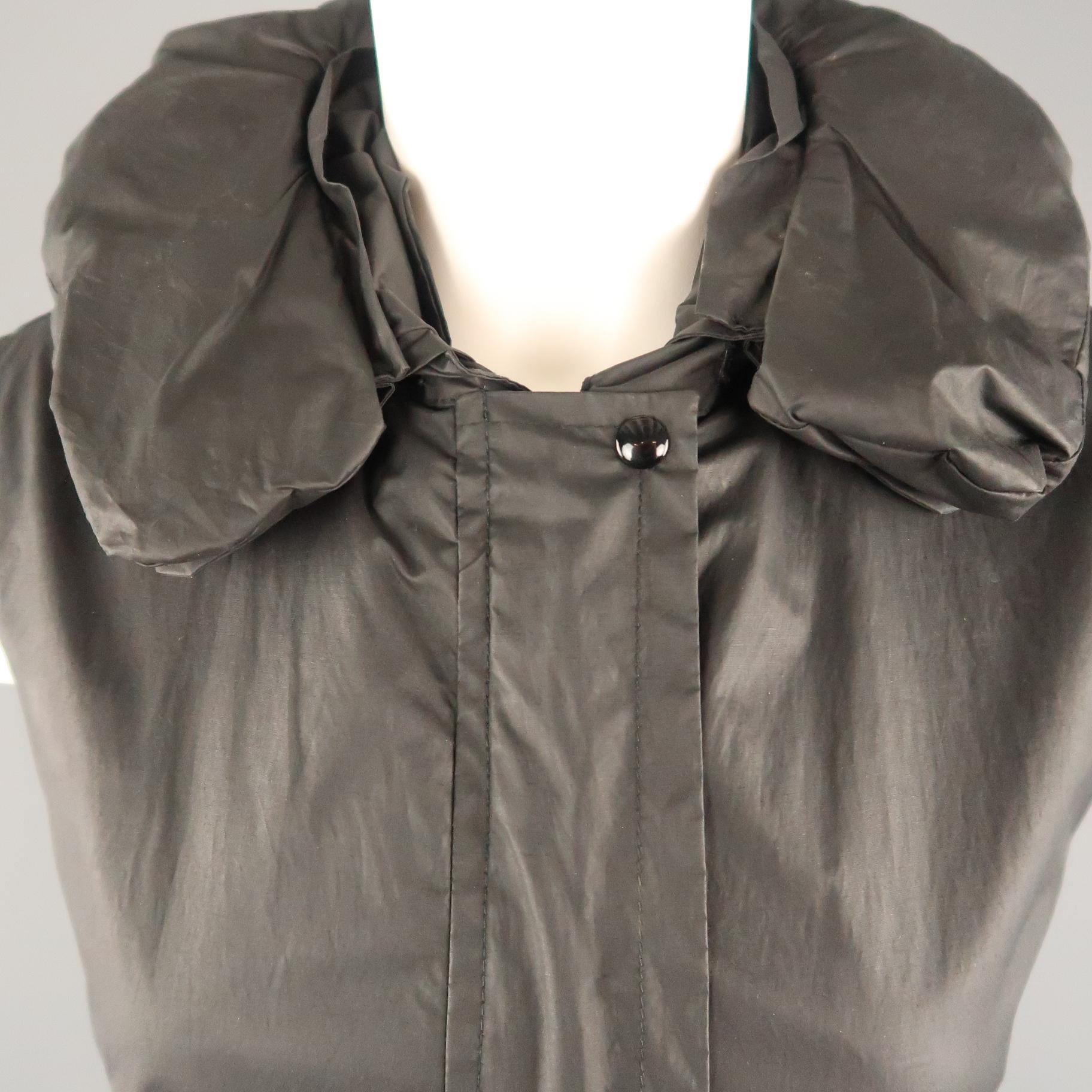 Archive 1999-2000 HELMUT LANG Astro parachute vest comes in coated fabric with with a hidden placket zip up front, side zip pockets, zip waistband, detachable zip out hoodie neck pillow collar, and iconic bondage strap interior. Very minor wear.