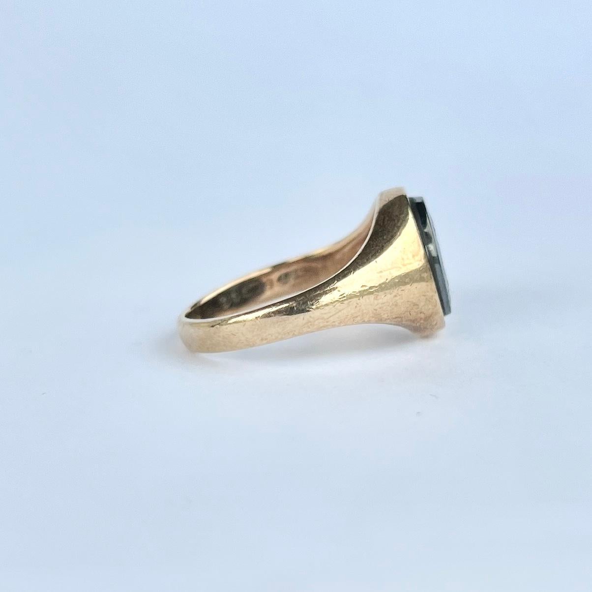 This glossy and shiny Hematite signet ring has a beautifully engraved soldier on the face. Made in Birmingham, England 1970.

Ring Size: M or 6 1/4 
Stone Face dimensions: 10x8mm

Weight: 3.4g
