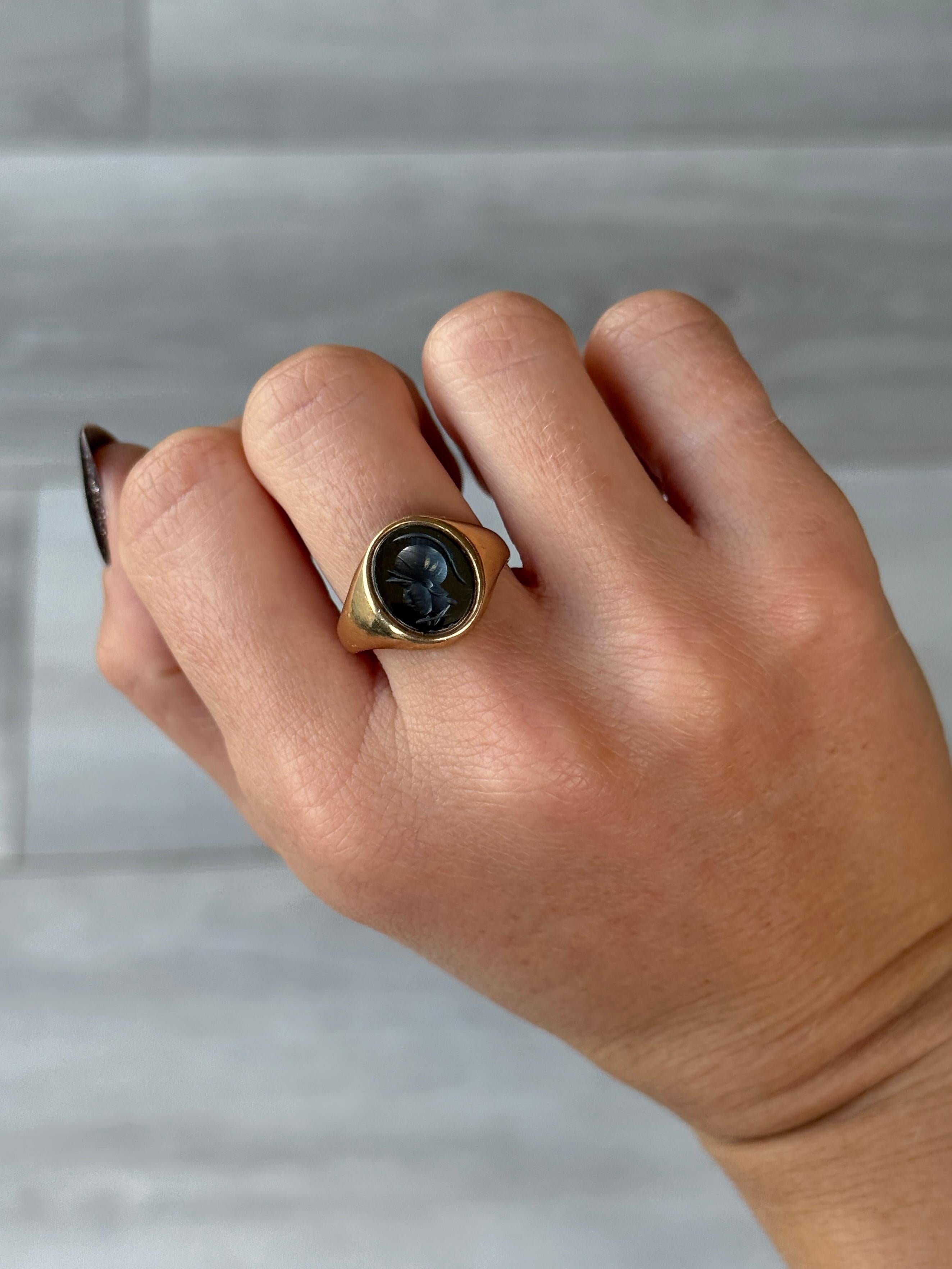 Questo anello con sigillo in ematite, lucido e brillante, presenta una splendida incisione di un soldato sulla faccia. Prodotto a Birmingham, Inghilterra 1980.

Misura dell'anello: P & A 7 3/4
Dimensioni della faccia della pietra: 12x10mm

Peso: 4,4