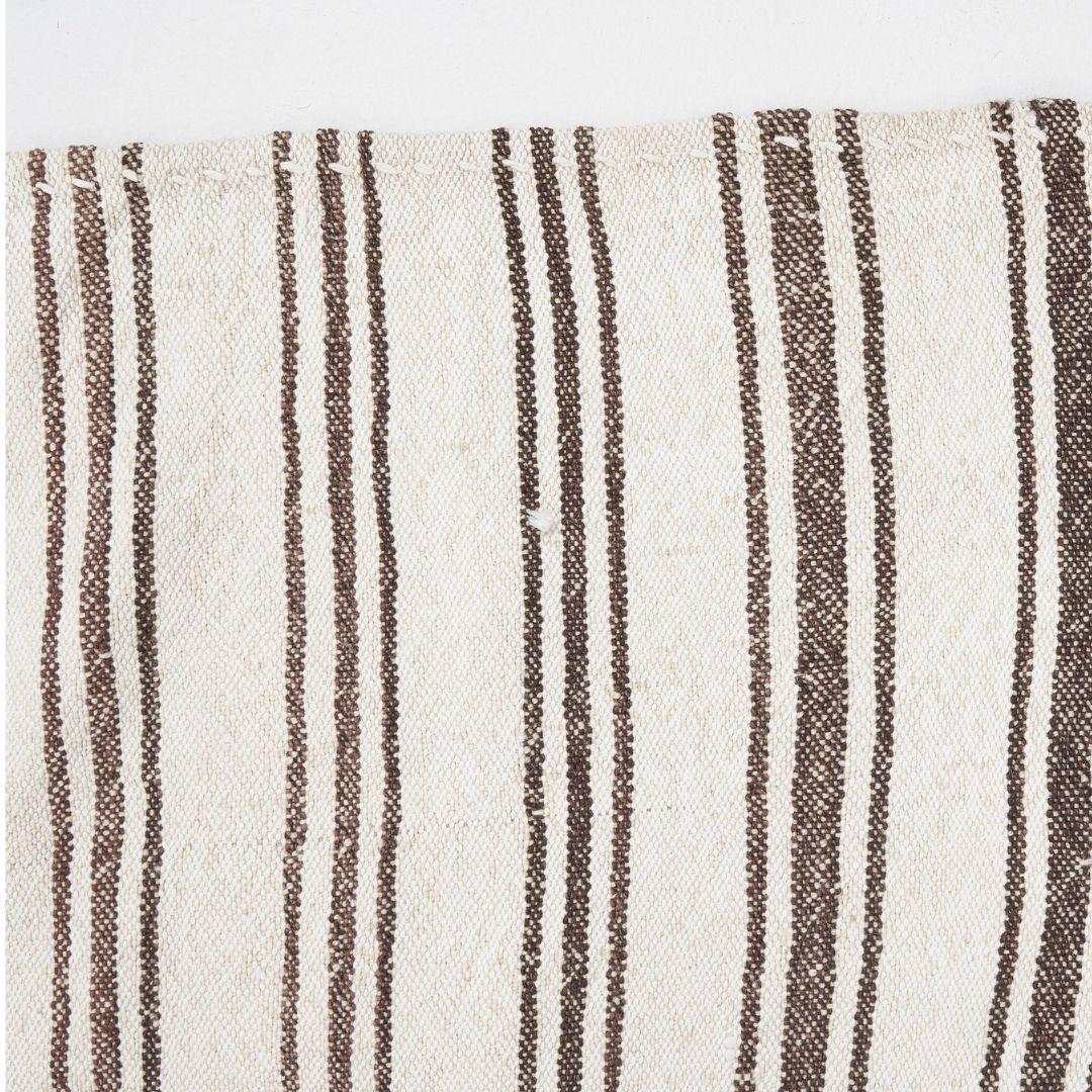 Handmade in Turkey, this vintage wool stripe rug in natural beige and brown tones is both timeless and contemporary. 

Our Turkish rugs are made using ancient art forms passed down through generations. Skilled artisans use traditional techniques