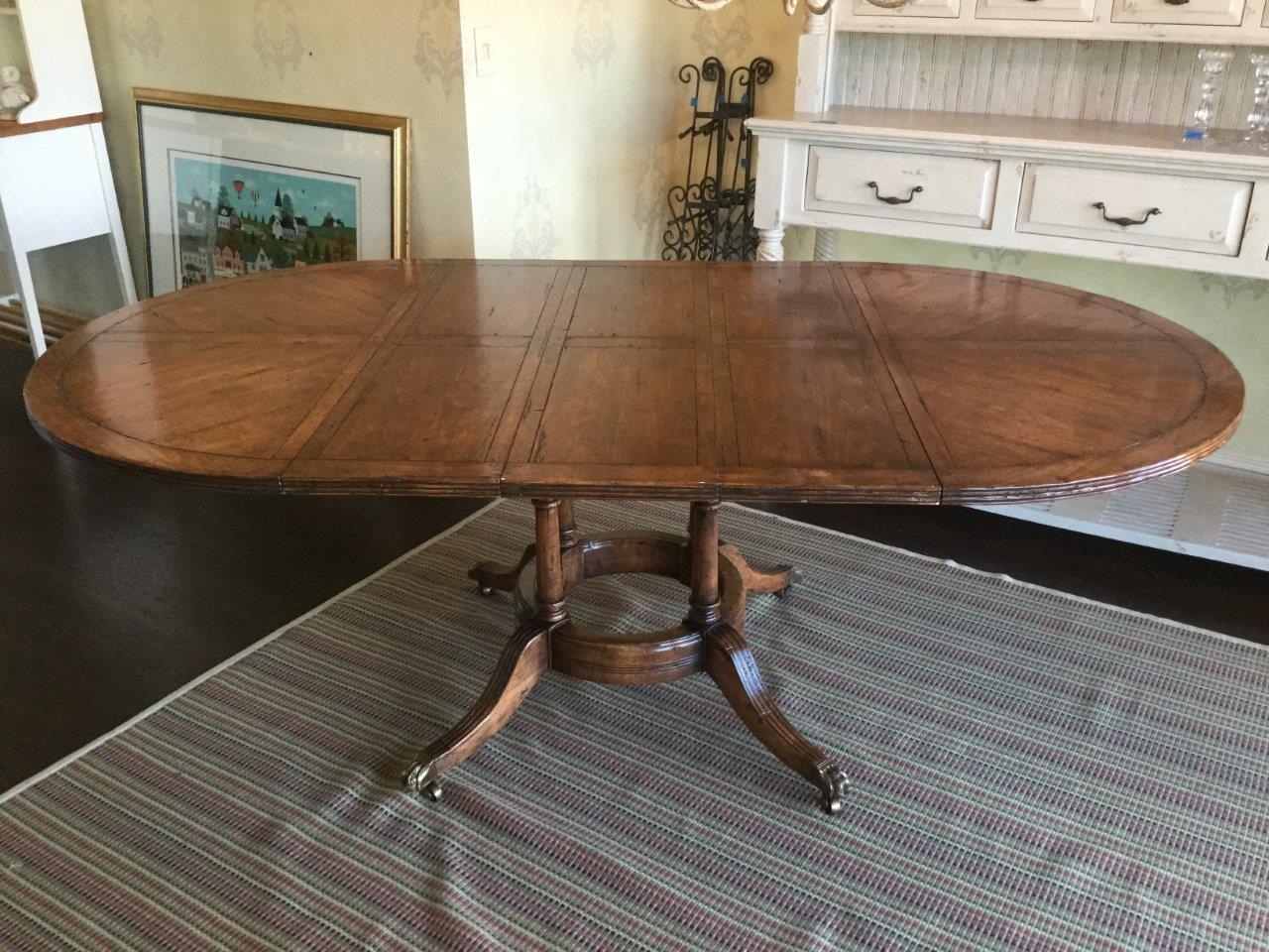Beautiful high quality dining table with a great patina. Without the 3 leaves, it’s a 48 inch round table on a pedestal base. With the leaves, each measuring 12 inches, this table extends to 84 inches. Made of aged cherry wood, you will love the
