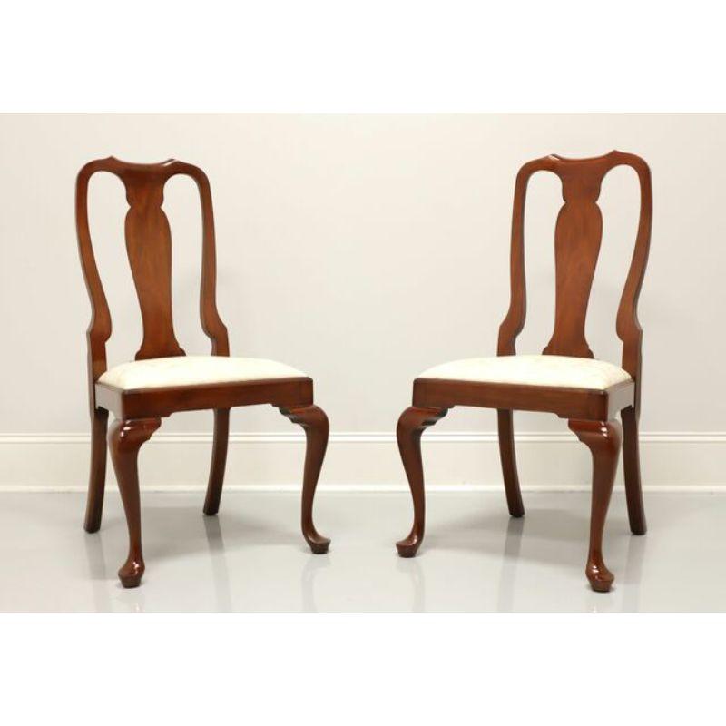 A pair of Queen Anne style dining side chairs by Henkel Harris of Winchester, Virginia, USA. Solid wild black cherry with cream color brocade fabric upholstered seats, cabriole legs and pad feet. Made circa 1992.

Style #: 105S, Finish #: