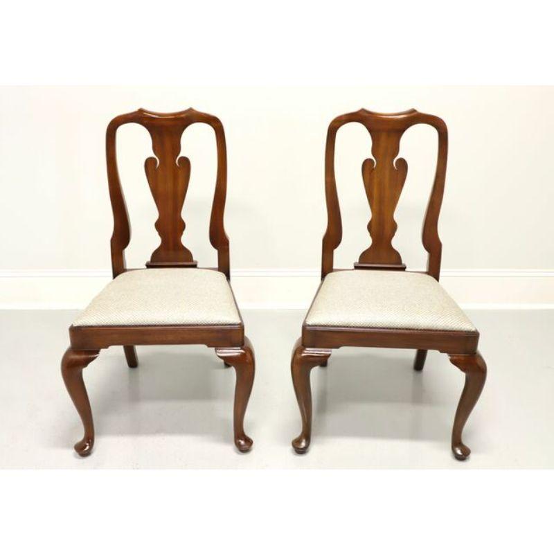 A pair of Queen Anne style dining side chairs by Henkel Harris of Winchester, Virginia, USA. Solid Mahogany with carved backs, silver check patterned fabric upholstered seat, cabriole legs and pad feet. Made circa 1987.

Style #: 110S, Finish #: