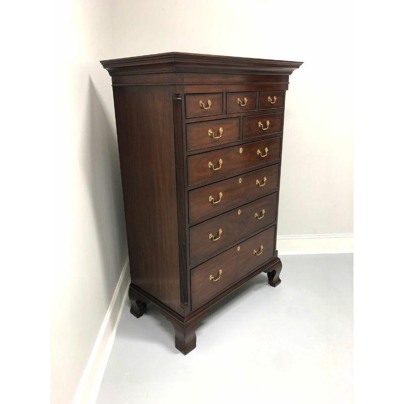 A Chippendale style chest of drawers by quality furniture maker Henkel Harris. Solid mahogany with brass hardware. Features nine dovetailed drawers with four larger drawers being lockable with key, fluted quarter columns and bracket feet. Includes