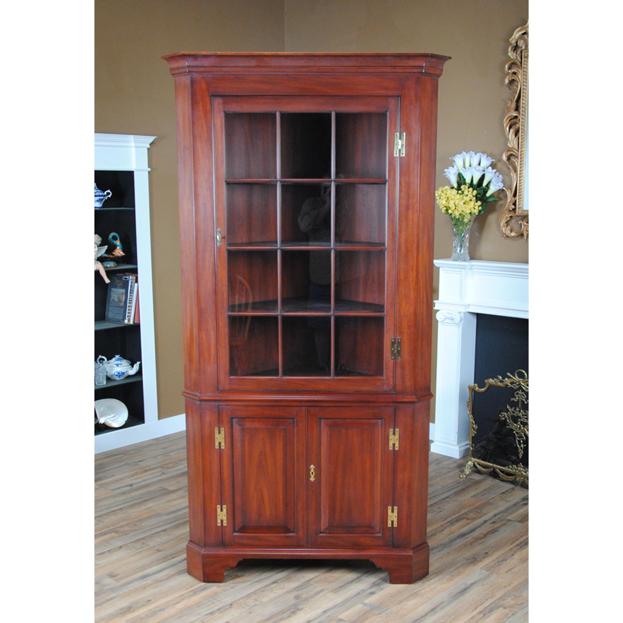 This Vintage Henkel Harris Corner Closet is manufactured using solid cherry on all exposed surfaces and a plywood back. The attention to detail and expert craftsmanship is apparent throughout this china closet in details such as the still