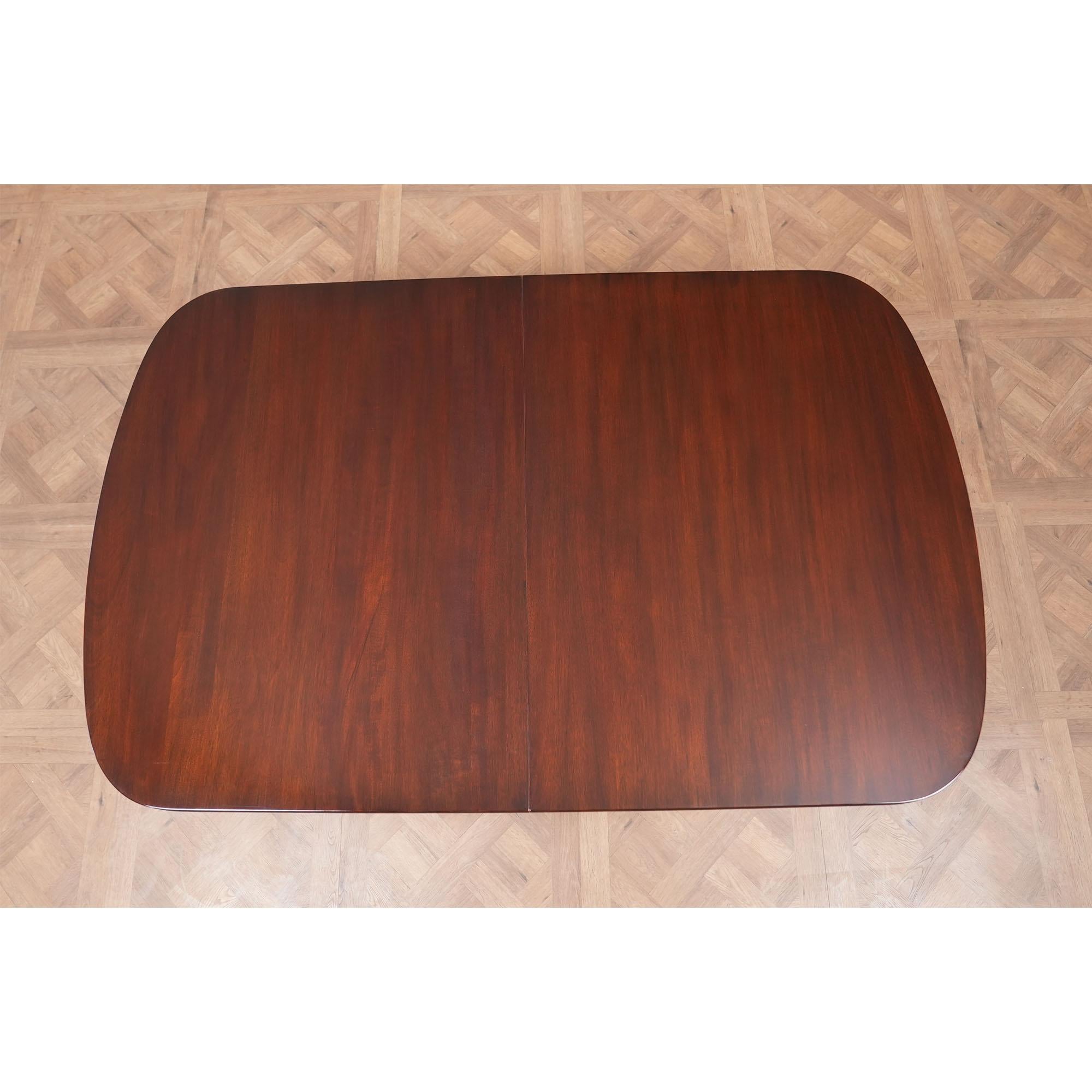 A Vintage Henkel Harris Dining Table brought to you by Niagara Furniture. This table is impressive in both it’s design and scale. Made of beautifully grained solid mahogany, the Vintage Henkel Harris Dining Table has three extra leaves to extend the