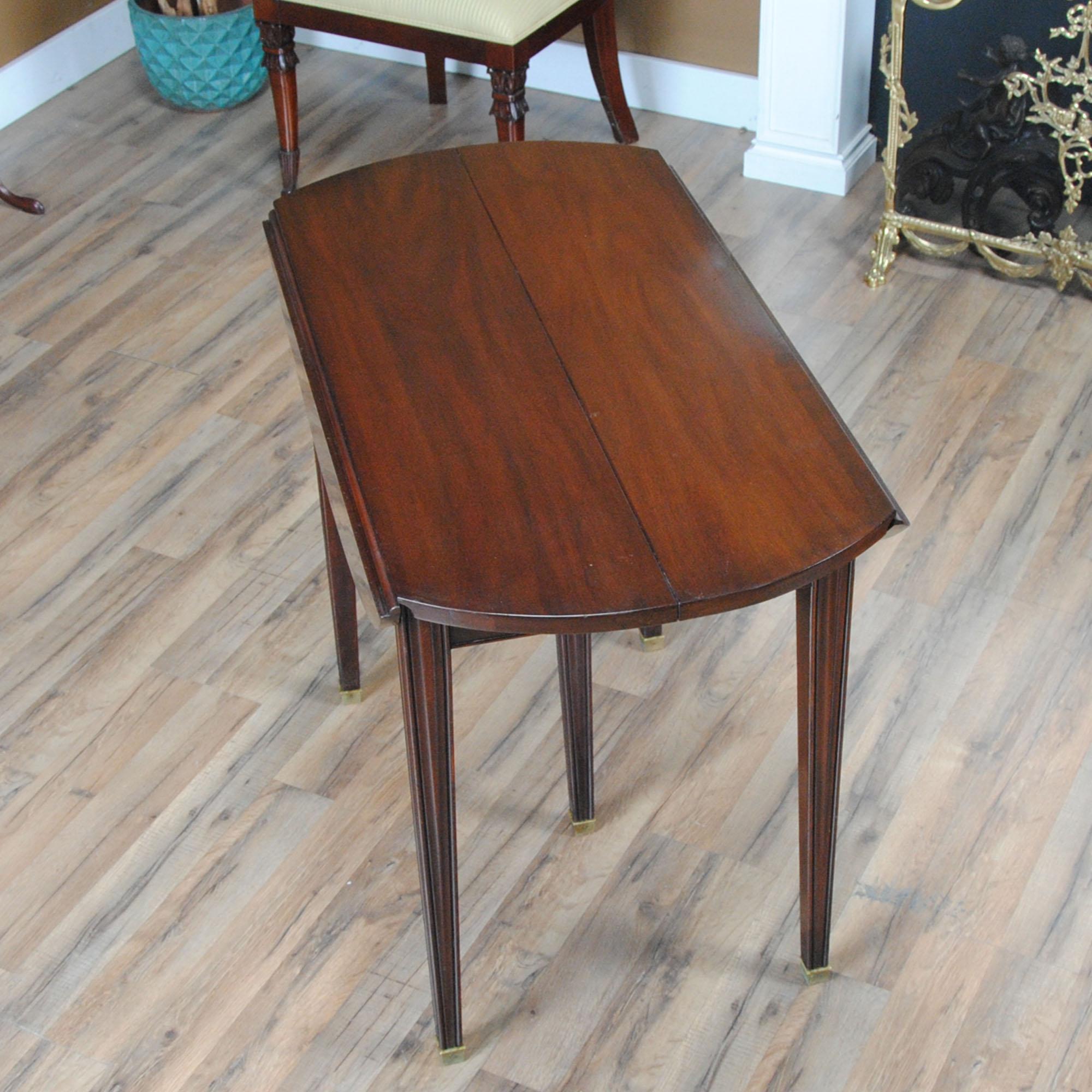 This Vintage Henkel Harris Dropside Table with Leaf was manufactured using solid mahogany on all exposed surfaces. The attention to detail and expert craftsmanship is apparent throughout this table in details such as the still functioning original