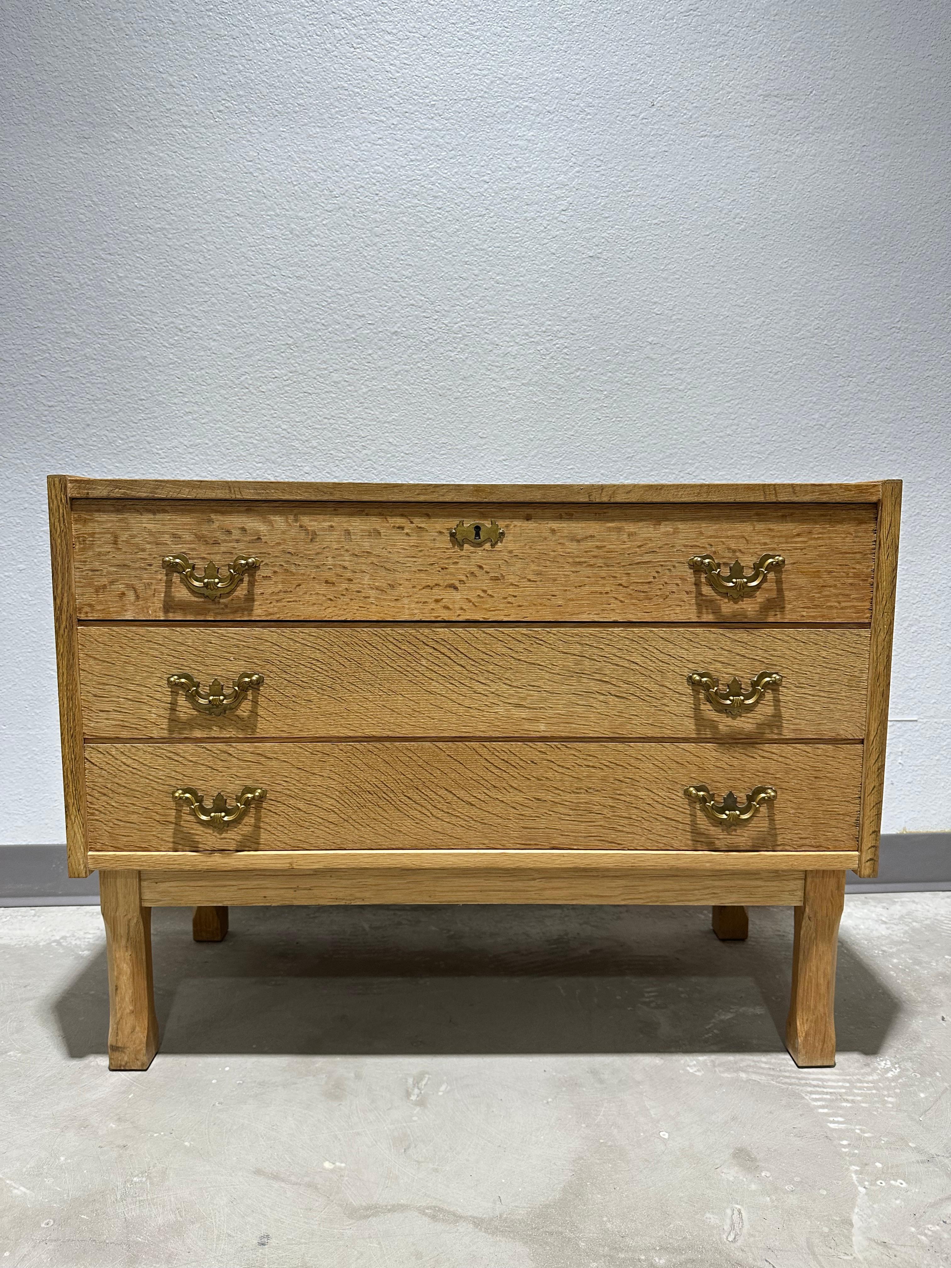 Vintage 1970’s Danish Oak Brutalist Small boy dresser/chest of drawers in the style of Henning Kjærnulf. Rustic design in light natural oak with carved legs, 3 drawers, and brass pulls. Good vintage condition, minimal age appropriate wear, no